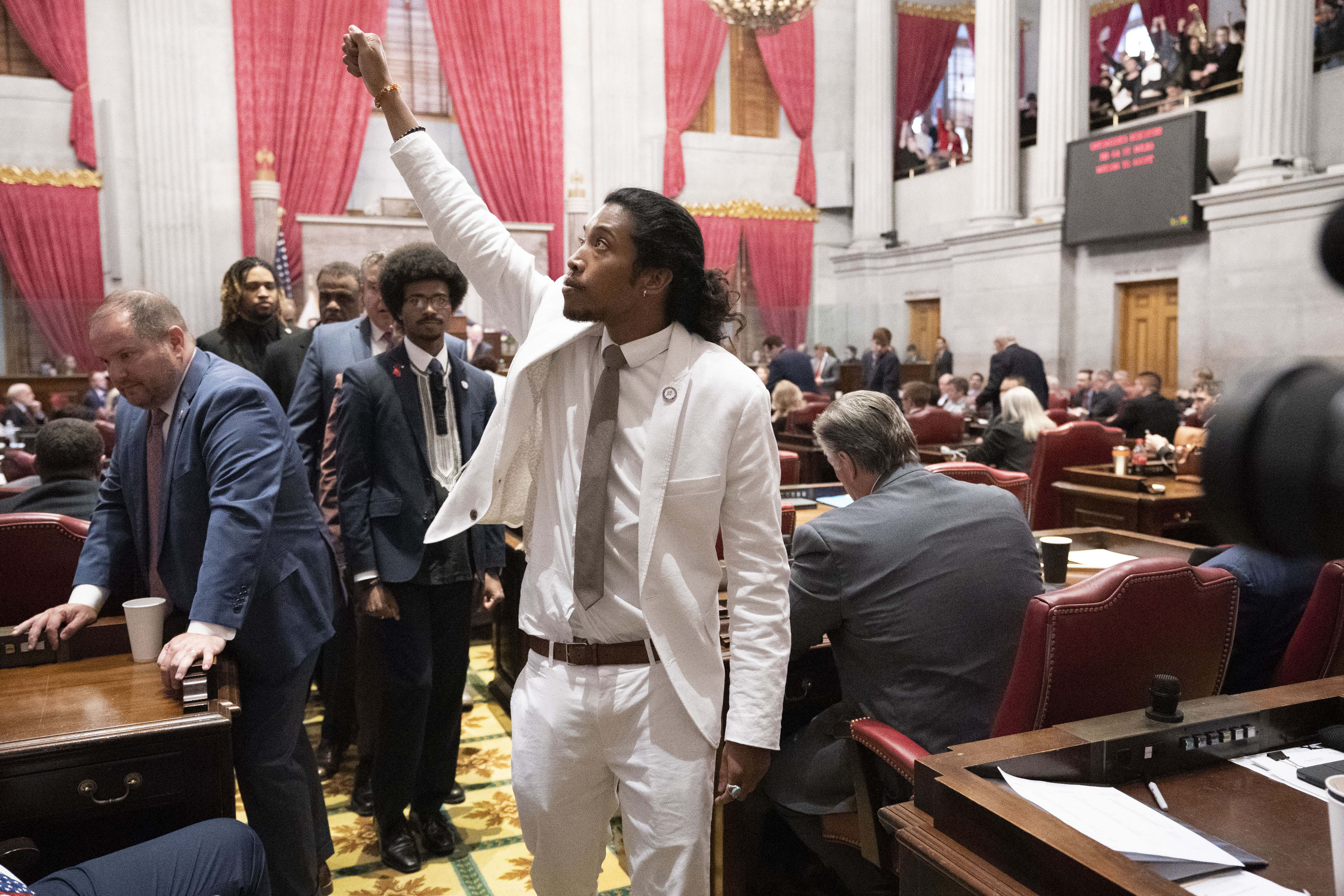 Former Rep. Justin Jones, D-Nashville, raises his fist on the floor of the House chamber as he walks to his desk to collect his belongings after being expelled from the legislature on Thursday, in Nashville, Tenn.