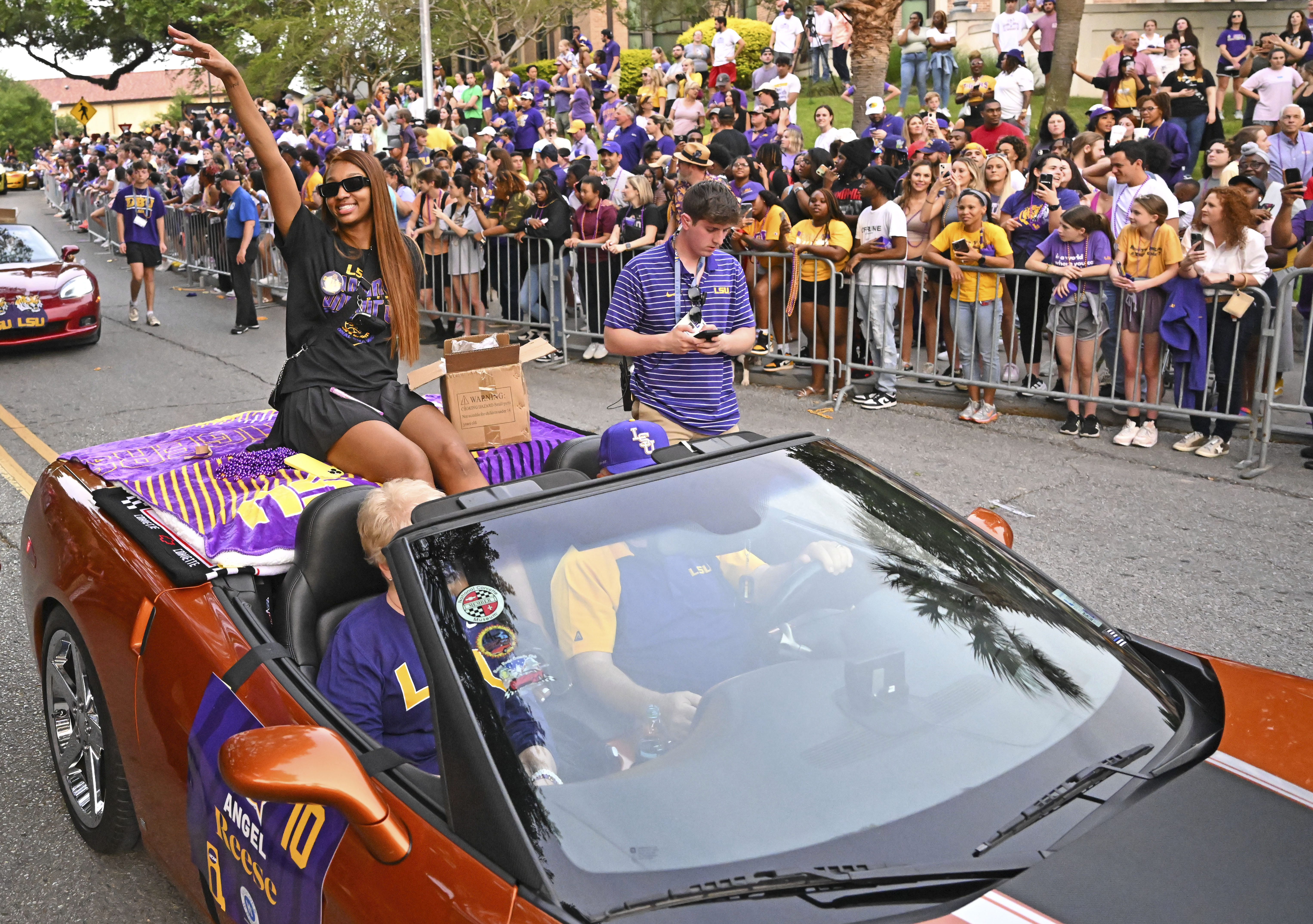 LSU forward Angel Reese waves to fans as the women's NCAA college national champion basketball team paraded across campus in Baton Rouge, La., Wednesday, April 5, 2023. 