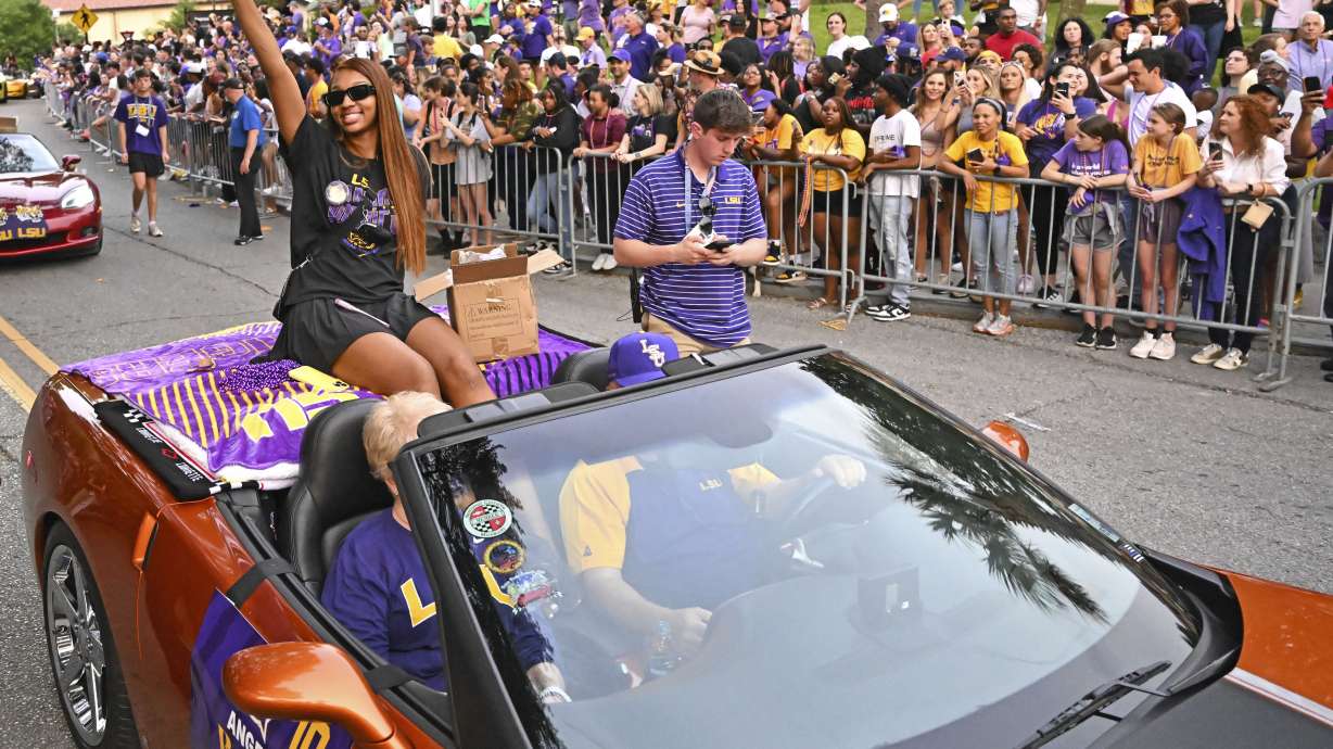 LSU forward Angel Reese waves to fans as the women's NCAA college national champion basketball team paraded across campus in Baton Rouge, La., Wednesday, April 5, 2023.