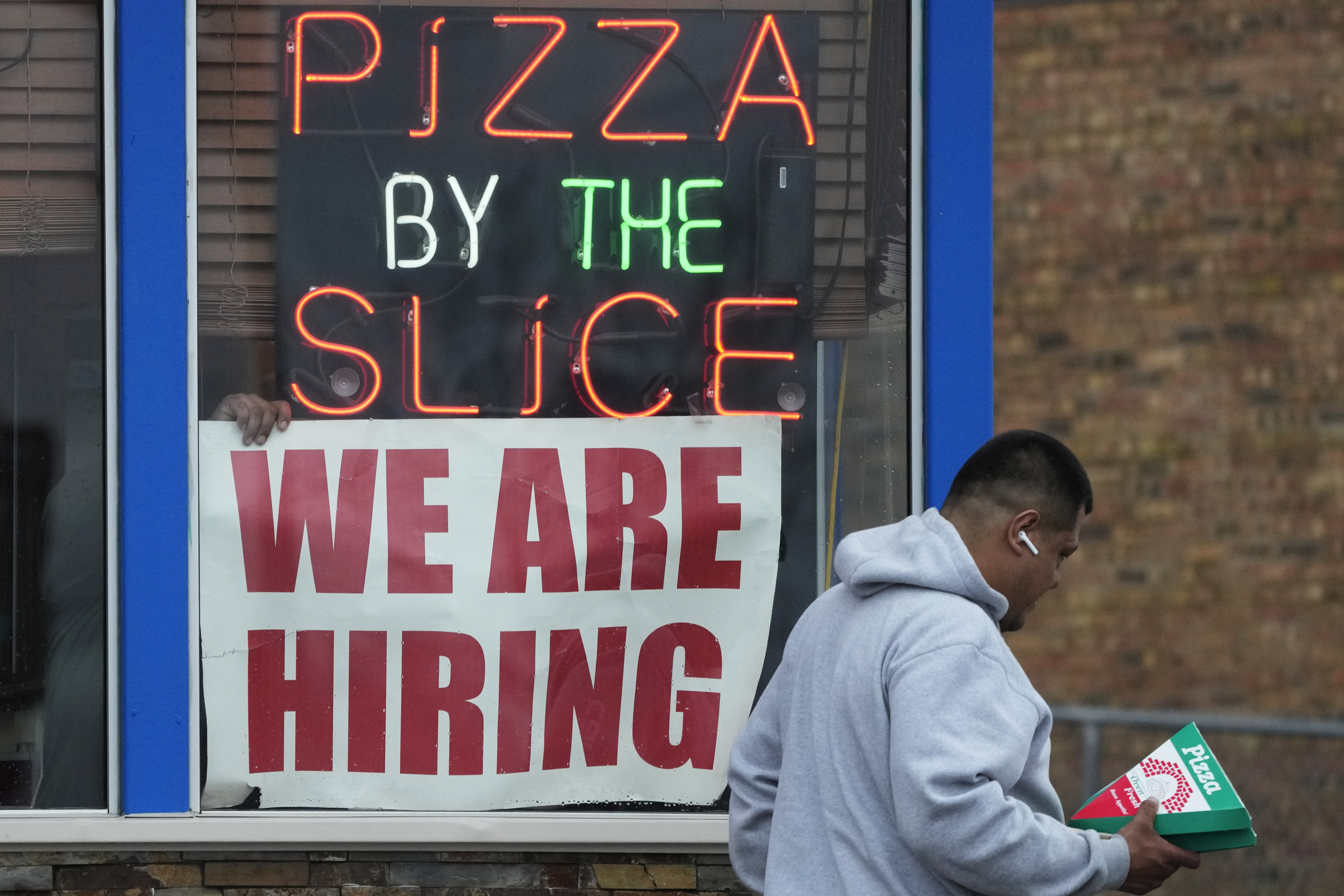 A hiring sign is displayed at a restaurant in Prospect Heights, Ill., Tuesday. On Friday, the government said America's employers added a solid 236,000 jobs in March.