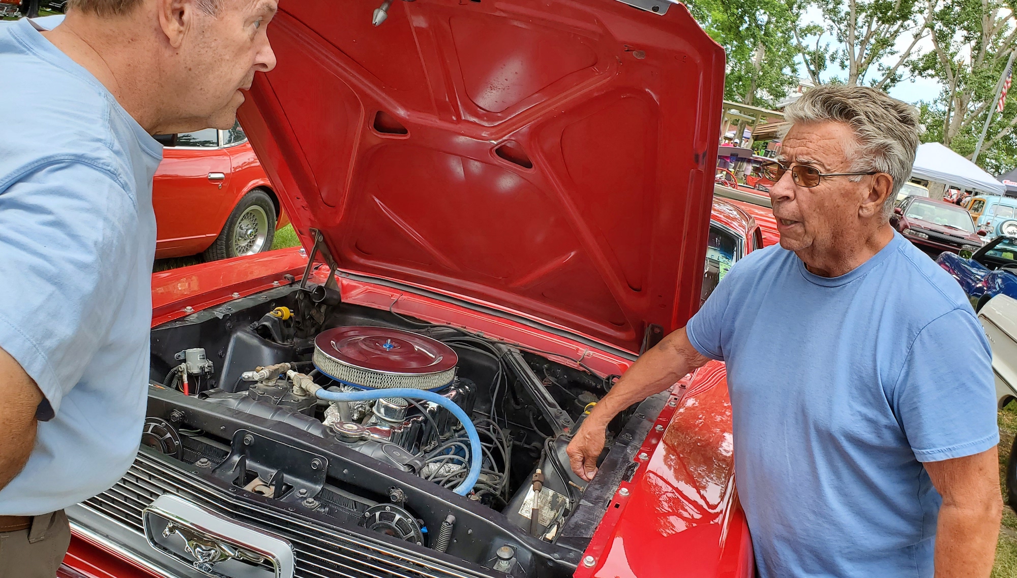 Scott McNair, right, explains to Larry Hoxer the differences between the California Mustang he probably built vs. the eastern-built models, at the Cache Valley Cruise-In, June 30, 2022, in Logan.