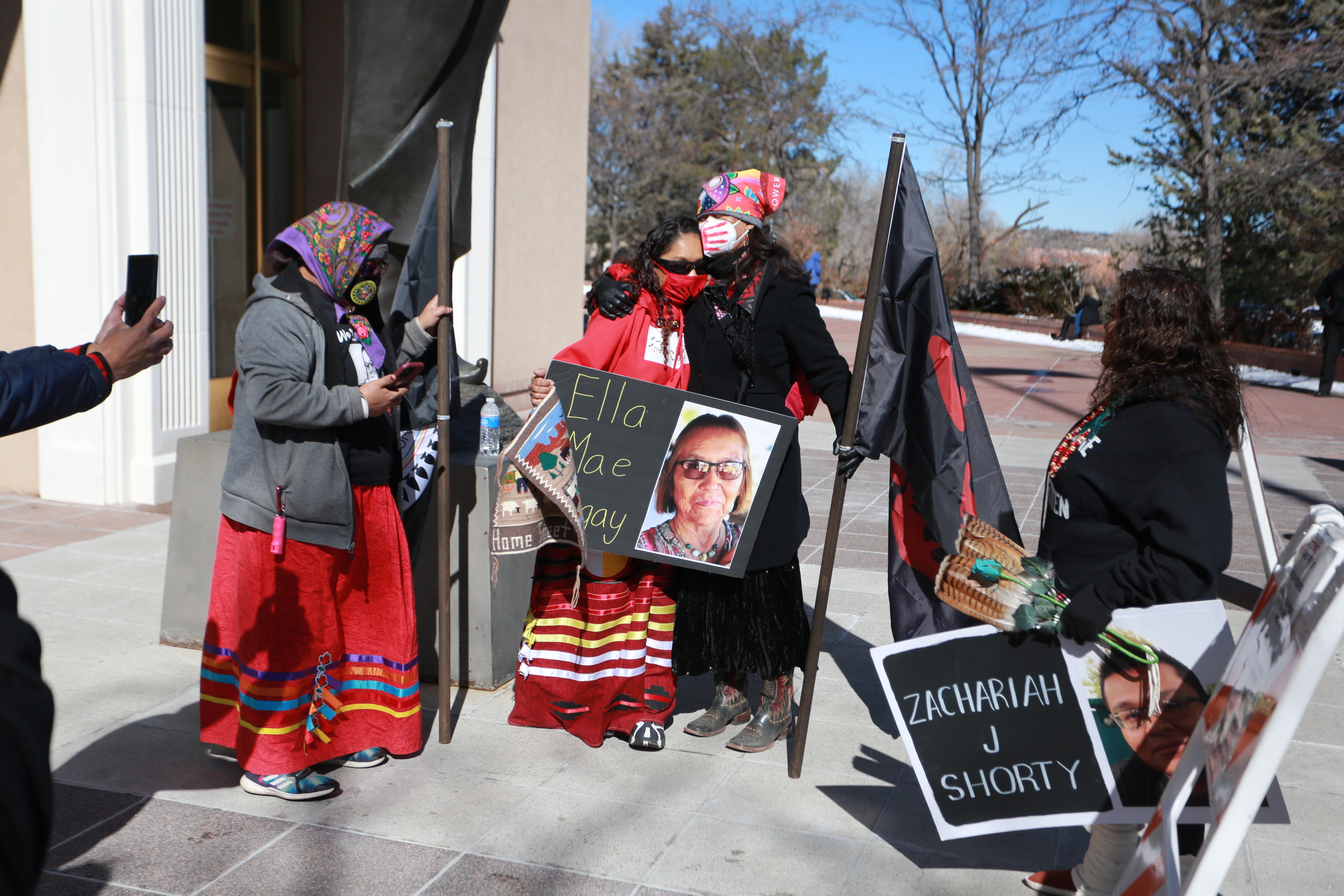 Seraphine Warren, center left, is embraced by state Sen. Shannon Pinto outside on Feb. 4, 2022, in Santa Fe, N.M. A federal grand jury has indicted a man on assault and carjacking charges in connection with the disappearance of Ella Mae Begay. 