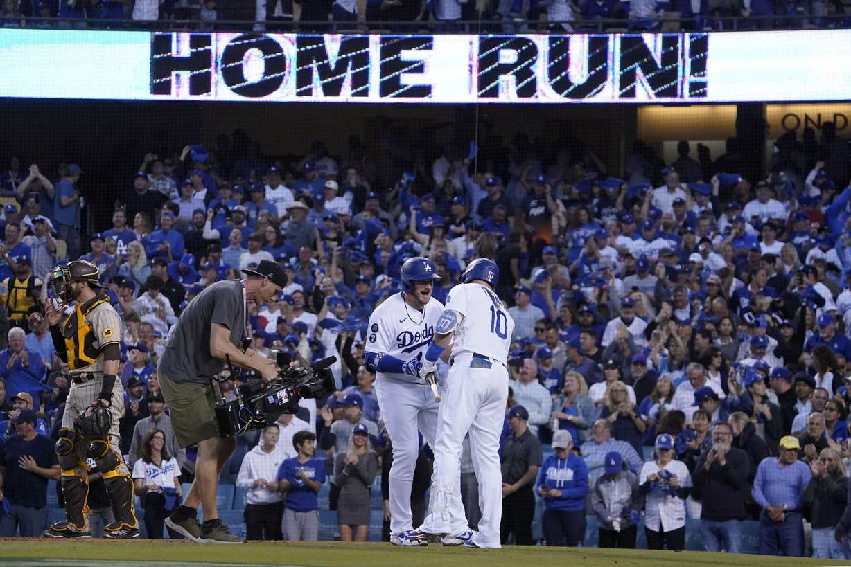 Los Angeles Dodgers' Max Muncy (13) celebrates his solo home run with Justin Turner (10) during a NL Division Series against the San Diego Padres, Oct. 12, 2022, in Los Angeles. A new study released Friday finds that climate change is making major league sluggers into even hotter hitters.