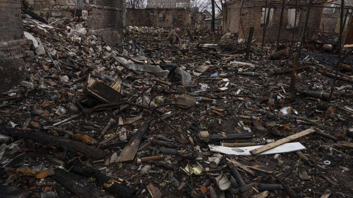 Ukrainian servicemen try to find undamaged shells in a burned-out ammunition depot which was destroyed after Russian attack near Kostiantynivka, Ukraine, Thursday.