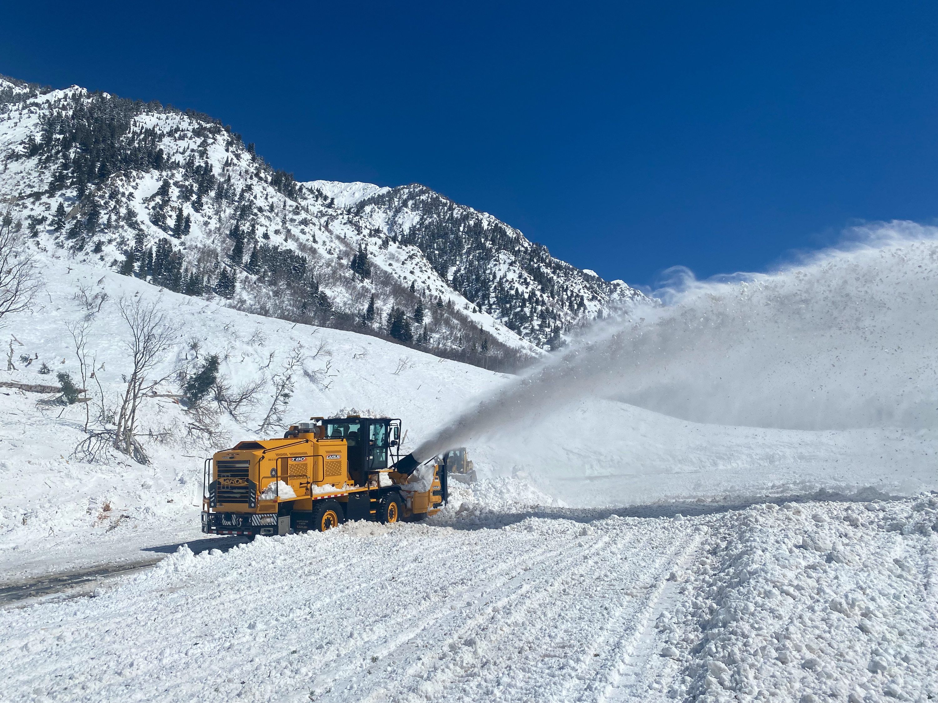 Crews from the Utah Department of Transportation use machines to clear avalanche debris that covered the road in Little Cottonwood Canyon on Thursday.
