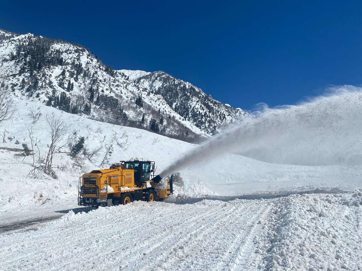 Crews from the Utah Department of Transportation use machines to clear avalanche debris that covered the road in Little Cottonwood Canyon on Thursday.