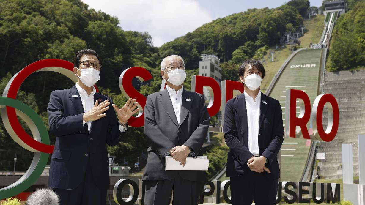 Sapporo Mayor Katsuhiro Akimoto, left, speaks during a news conference at a proposed site for the Winter Olympics ski jump in Sapporo, northern Japan, on July 30, 2022. Sapporo may soon be back in the race to host the 2030 Winter Games.