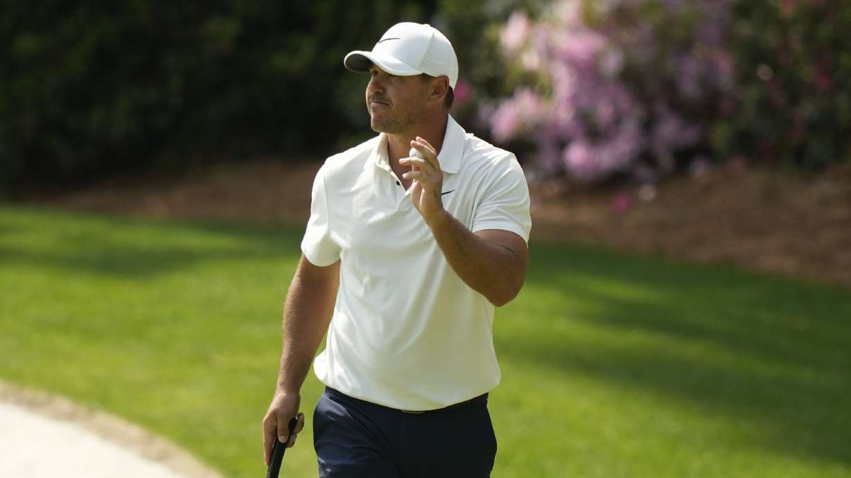 Brooks Koepka waves after his putt on the 13th hole during the second round of the Masters golf tournament at Augusta National Golf Club on Friday, April 7, 2023, in Augusta, Ga.