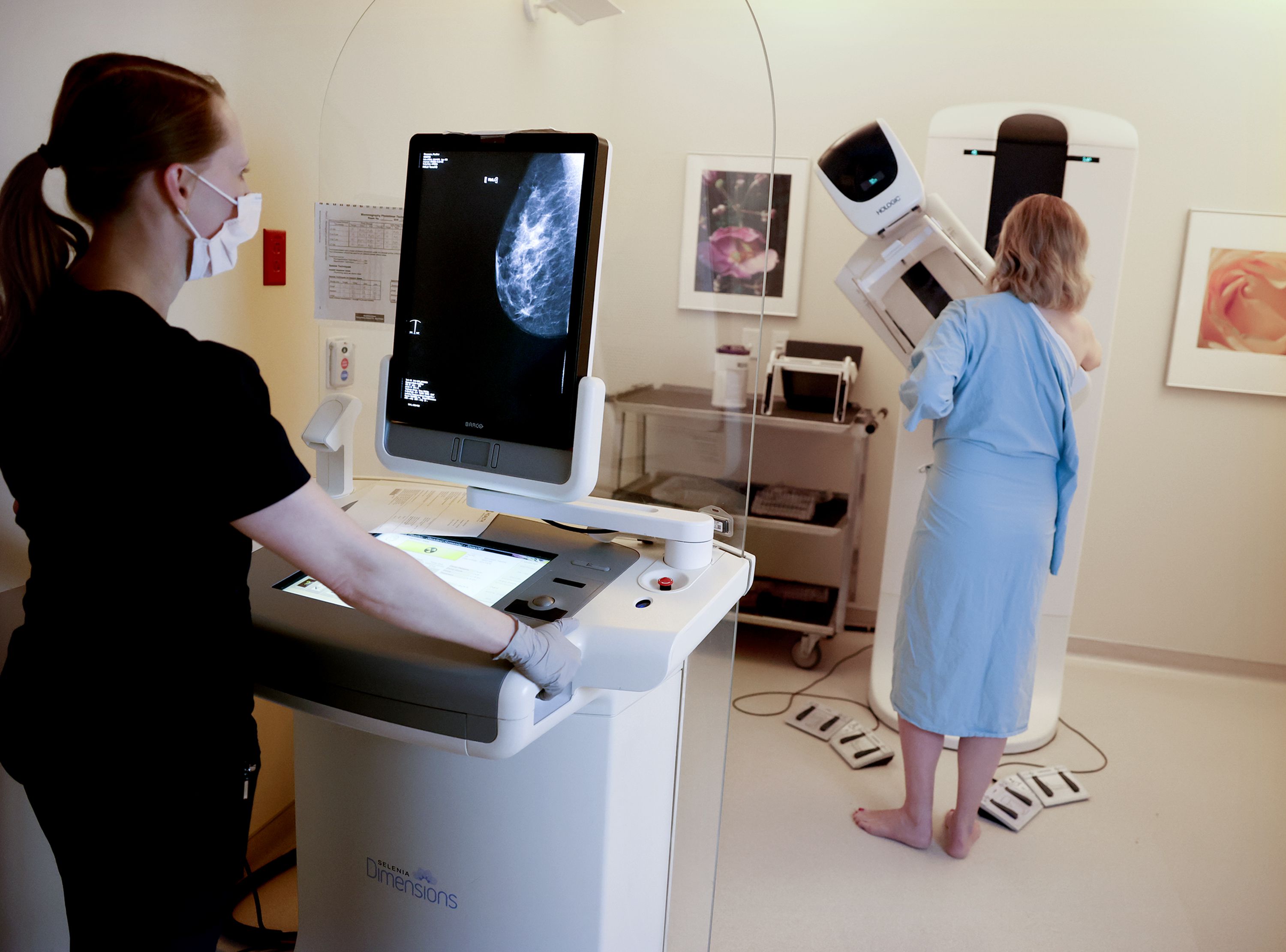 Registered radiologic technologist Holly Speer performs a mammogram on Heather Simonsen at the Huntsman Cancer Hospital in Salt Lake City on Friday.