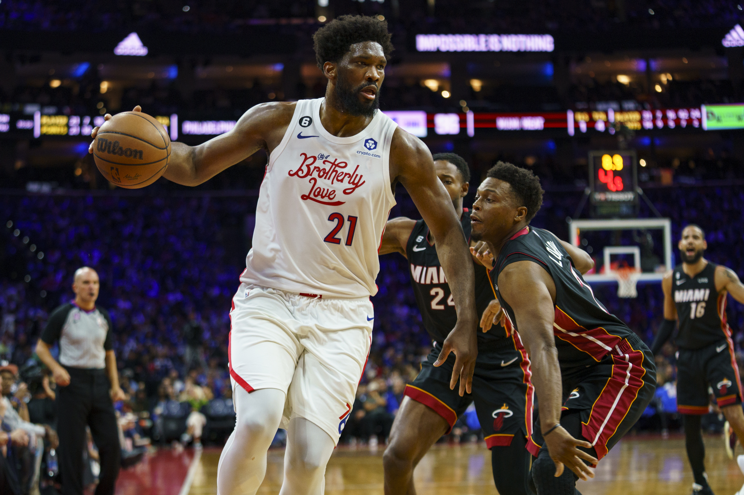 Philadelphia 76ers' Joel Embiid, left, looks to make his move against Miami Heat's Kyle Lowry, right, and Haywood Highsmith, center, during the second half an NBA basketball game, Thursday, April 6, 2023, in Philadelphia.