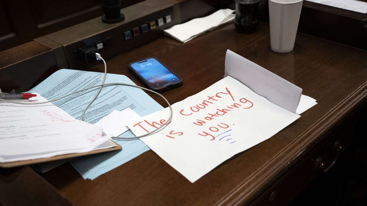 A sign rests on the desk of Rep. Gloria Johnson, D-Knoxville, in the House chamber as proceedings were brought to expel her from the legislature Thursday, in Nashville, Tenn.