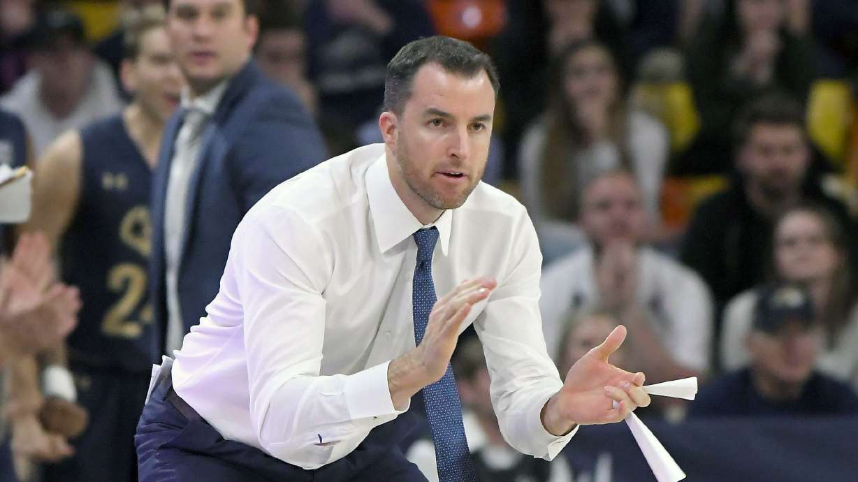 Montana State head coach Danny Sprinkle cheers on his team against Utah State during an NCAA college basketball game Tuesday, Nov. 5, 2019, in Logan, Utah.