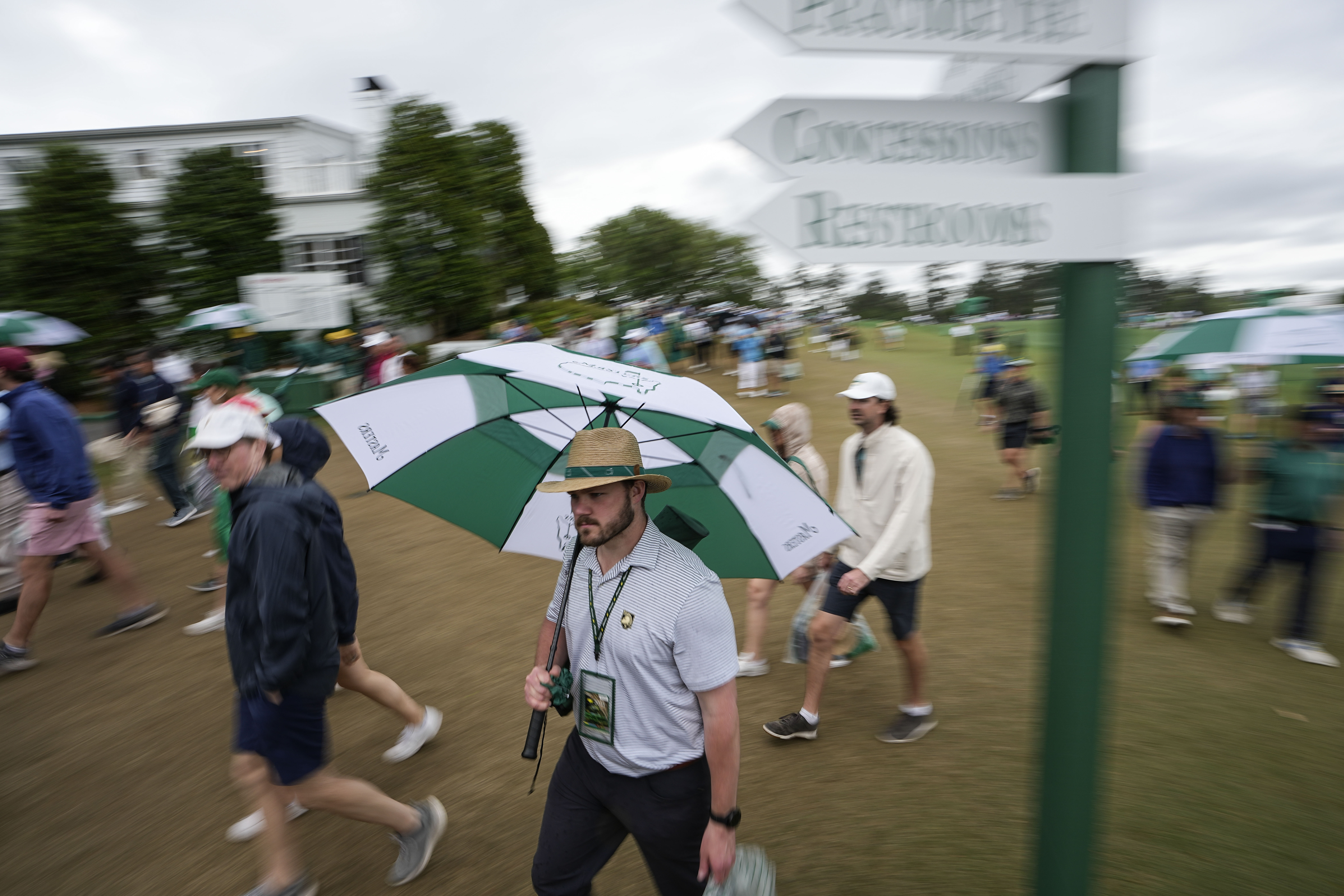 Patrons depart the course during a weather delay in the second round of the Masters golf tournament at Augusta National Golf Club on Friday, April 7, 2023, in Augusta, Ga.