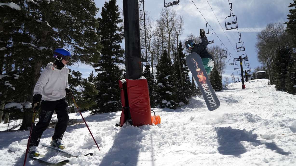 Race Lessar watches Landen Ozzello go off a jump they built at Parker-Fitzgerald Cuchara Mountain Park on March 19, near Cuchara, Colo. Race Lessar's dad used to race here and named his son for what brought him joy.