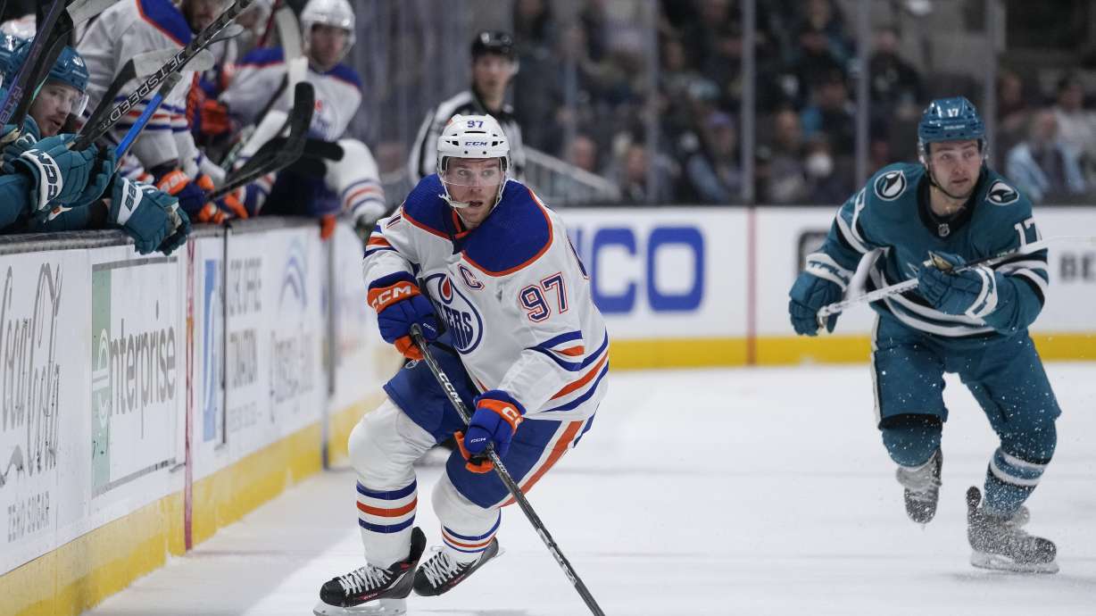 Edmonton Oilers center Connor McDavid move the puck against the San Jose Sharks during the first period of an NHL hockey game in San Jose, Calif., Saturday, April 8, 2023.
