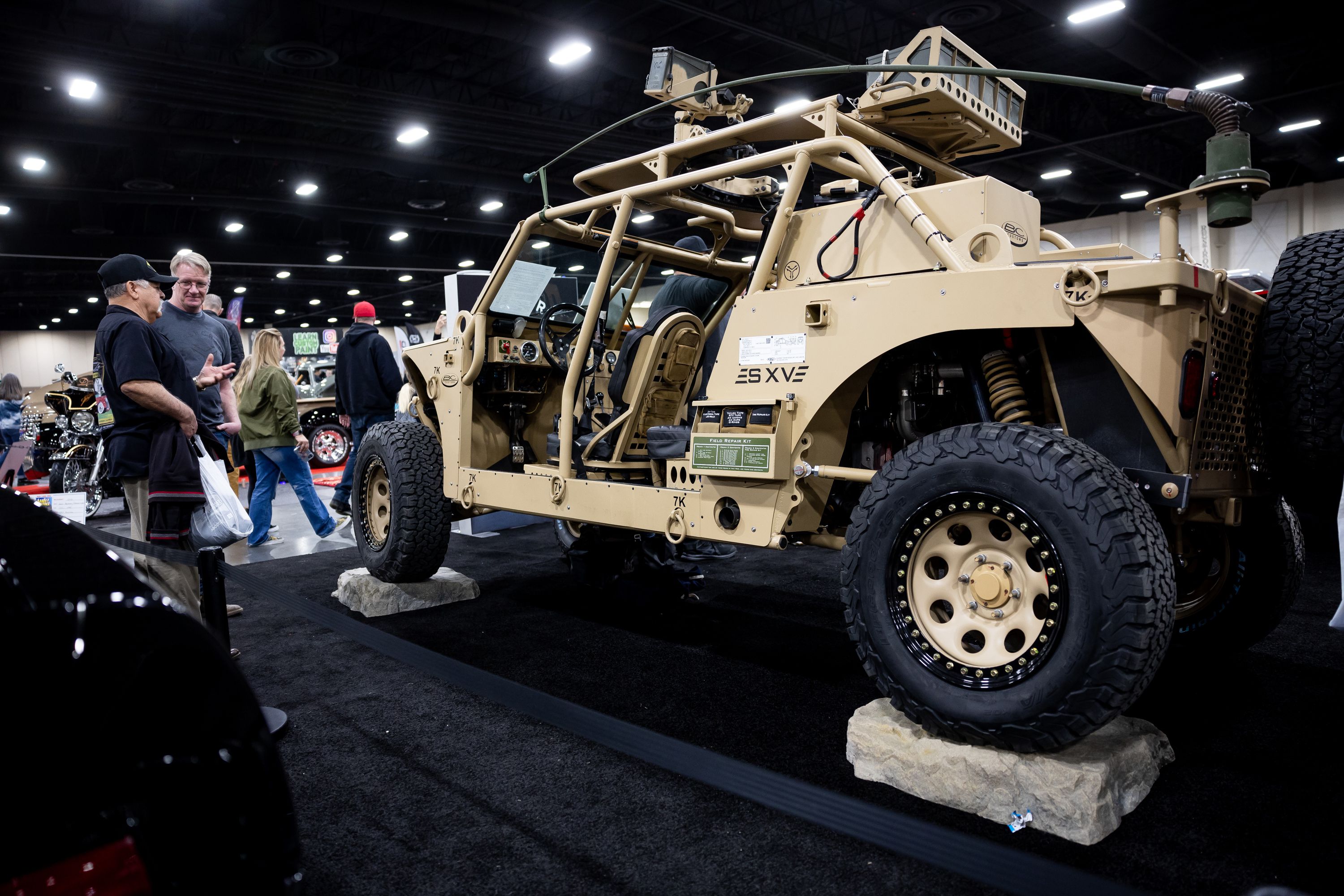 People look at a diesel and electric powered military vehicle at Hypercraft’s booth at the AutoRama car show at the Mountain America Expo Center in Sandy on Saturday, March 4.