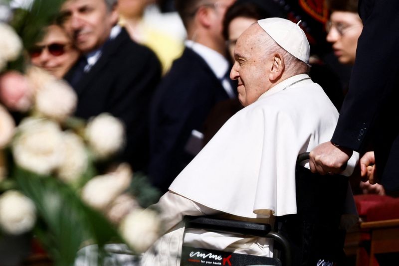 Pope Francis arrives to attend the Easter Sunday mass at St. Peter's Square at the Vatican on Sunday.