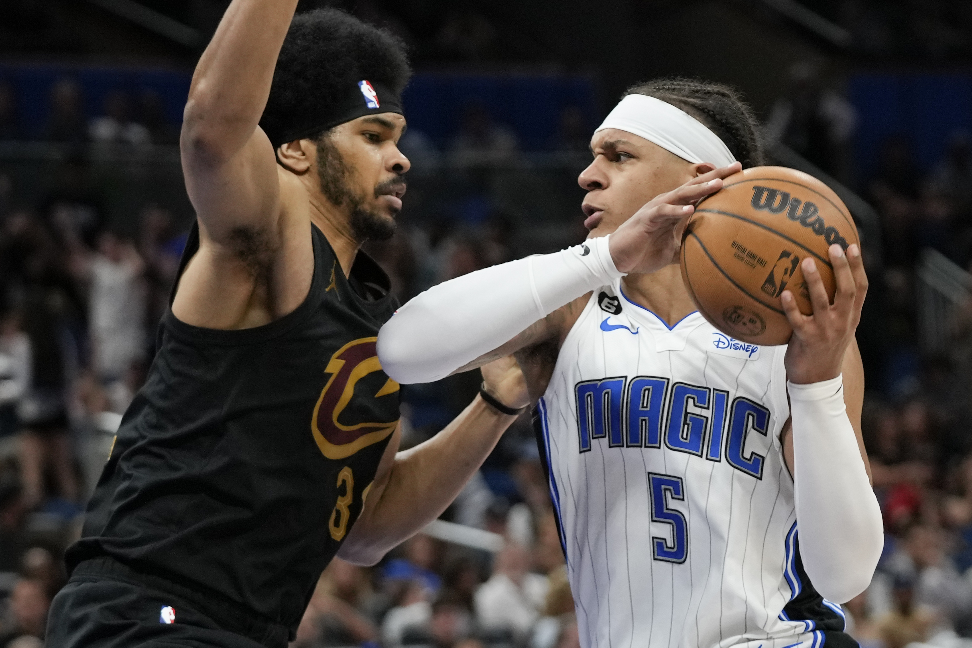 Orlando Magic's Paolo Banchero (5) makes a move to get past Cleveland Cavaliers Jarrett Allen during the second half of an NBA basketball game, Tuesday, April 4, 2023, in Orlando, Fla. 