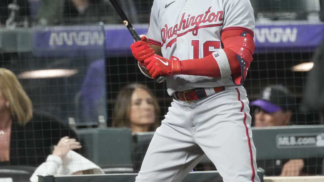 The pitch clock counts down as Washington Nationals' Victor Robles waits in the on-deck circle in the sixth inning of a baseball game against the Colorado Rockies, Saturday, April 8, 2023, in Denver.