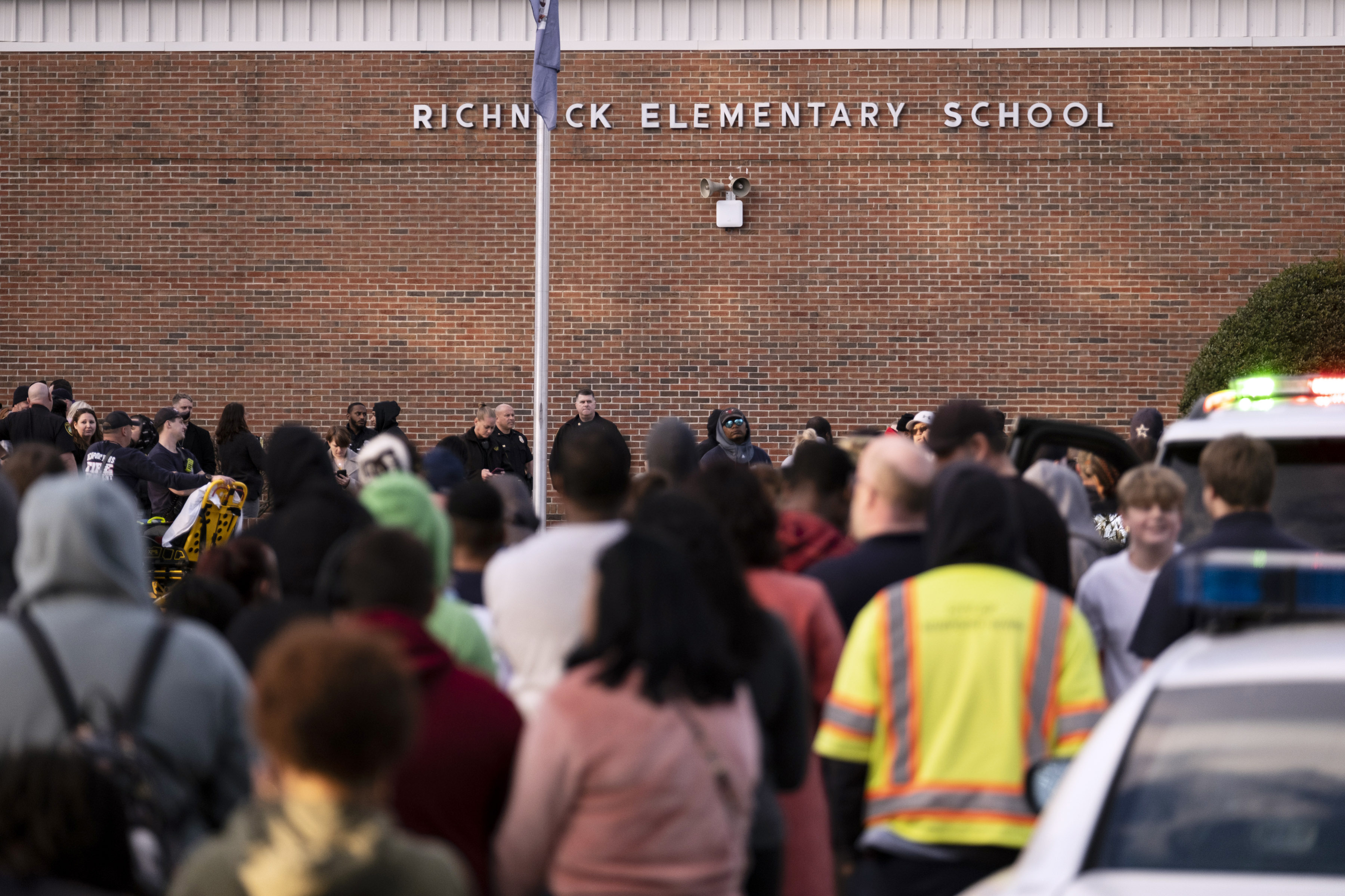 Students and police gather outside of Richneck Elementary School after a shooting, Jan. 6, 2023 in Newport News, Va. A grand jury in Virginia has indicted the mother of a 6-year-old boy who shot his teacher.