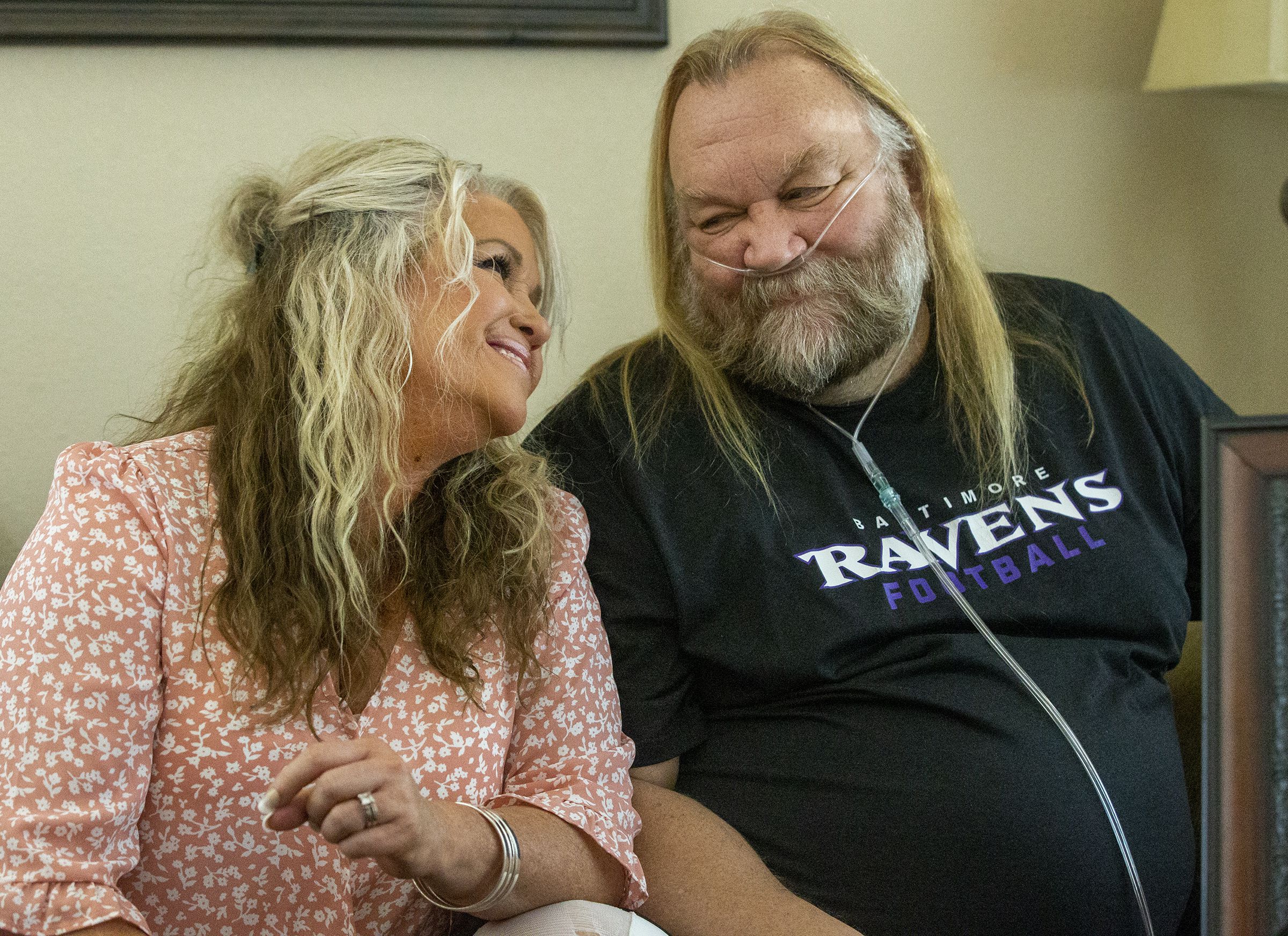 Stacey Ellsworth leans into her husband Stan Ellsworth at their home in Draper as they talk about their life together and Stan’s road to recovery from COVID-19 on Monday, July 6, 2020. Stan Ellsworth died on March 30, 2023.