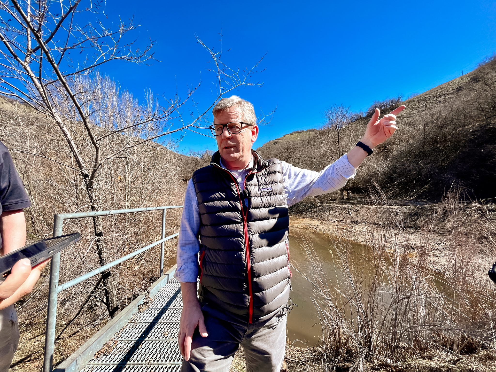 Salt Lake City Public Utilities Deputy Director Jesse Stewart points outward as he stands next to a catch basin at City Creek Canyon on Monday. The catch basin was installed in 1984 in response to the unprecedented flooding in 1983.
