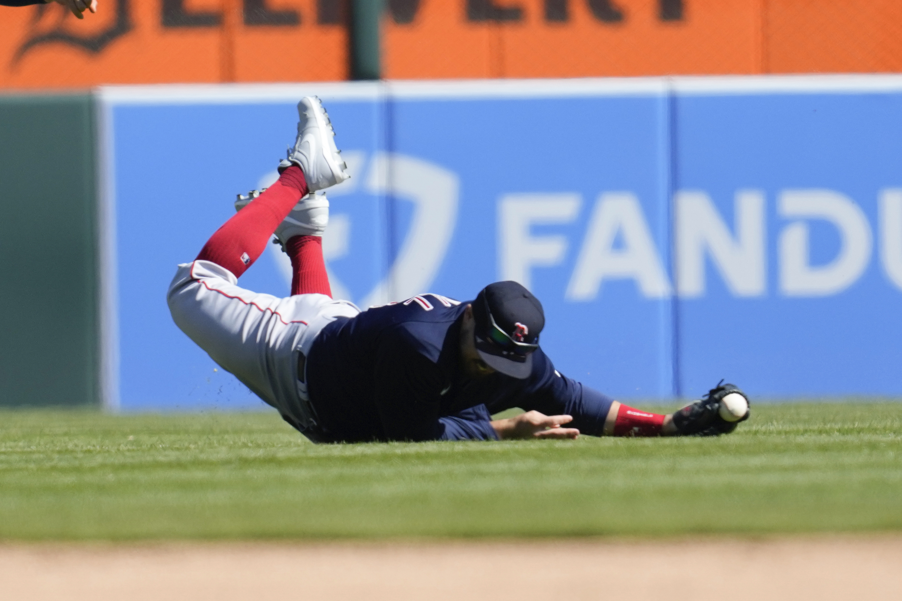 Boston Red Sox center fielder Adam Duvall loses the ball on a Detroit Tigers' Spencer Torkelson fly ball in the ninth inning of a baseball game in Detroit, Sunday, April 9, 2023. Duvall was injured on the play and left the game. 