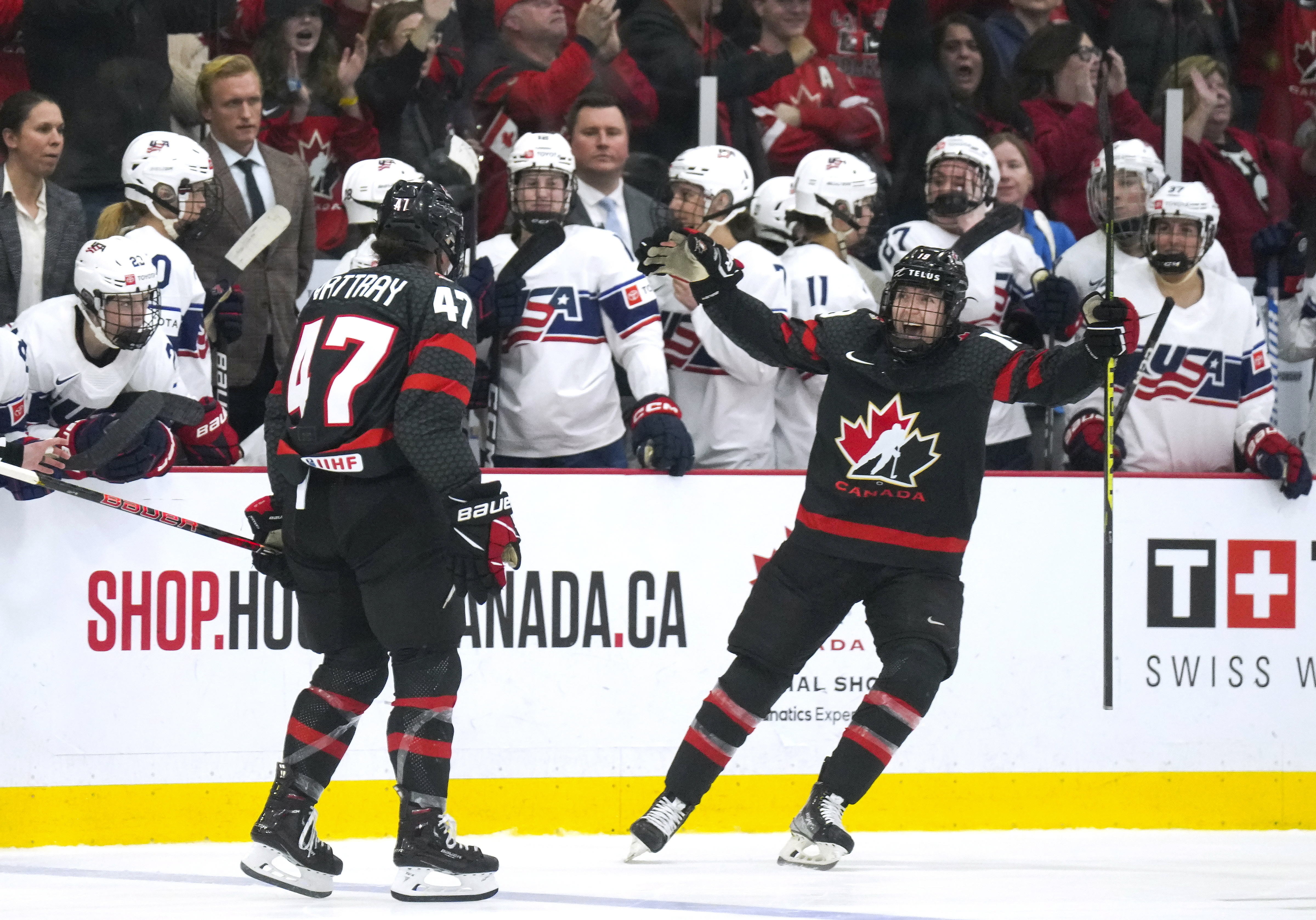 Canada forward Jamie Lee Rattray (47) celebrates with teammate Brianne Jenner (19) after defeating the United States in a shootout of a women's world hockey championships game in Brampton, Ontario, Monday, April 10, 2023. 