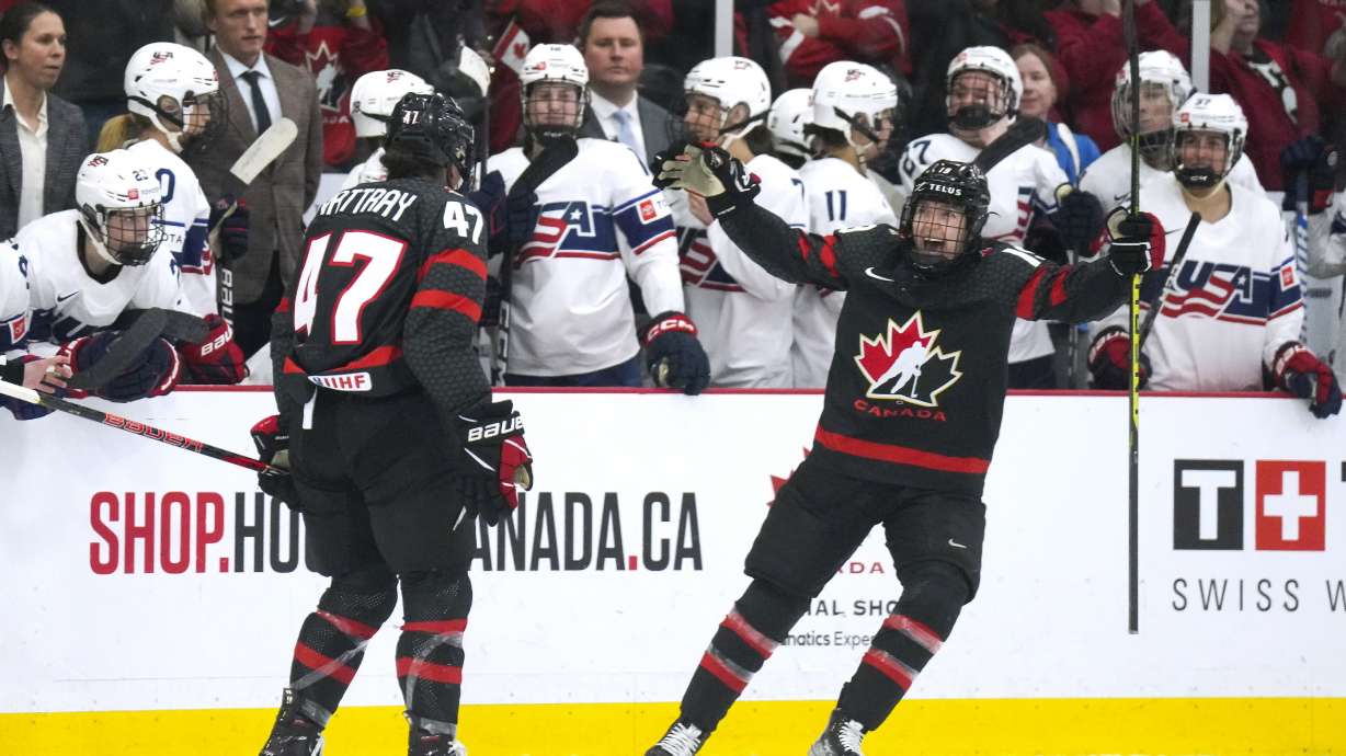 Canada forward Jamie Lee Rattray (47) celebrates with teammate Brianne Jenner (19) after defeating the United States in a shootout of a women's world hockey championships game in Brampton, Ontario, Monday, April 10, 2023.