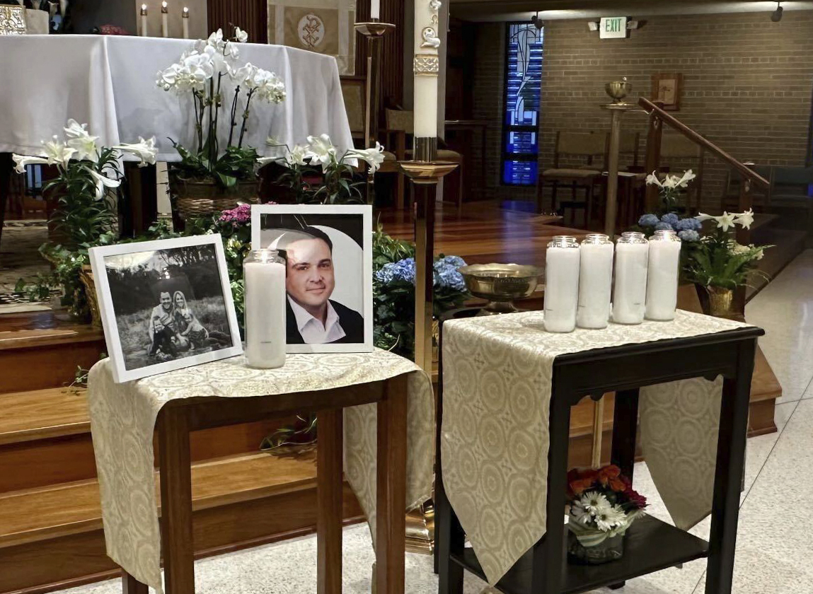 A memorial for Joshua Barrick is on display, late Monday at Holy Trinity Catholic Church in Louisville, Ky. A Louisville bank employee armed with a rifle opened fire at the bank Monday morning, killing Barrick and multiple others.