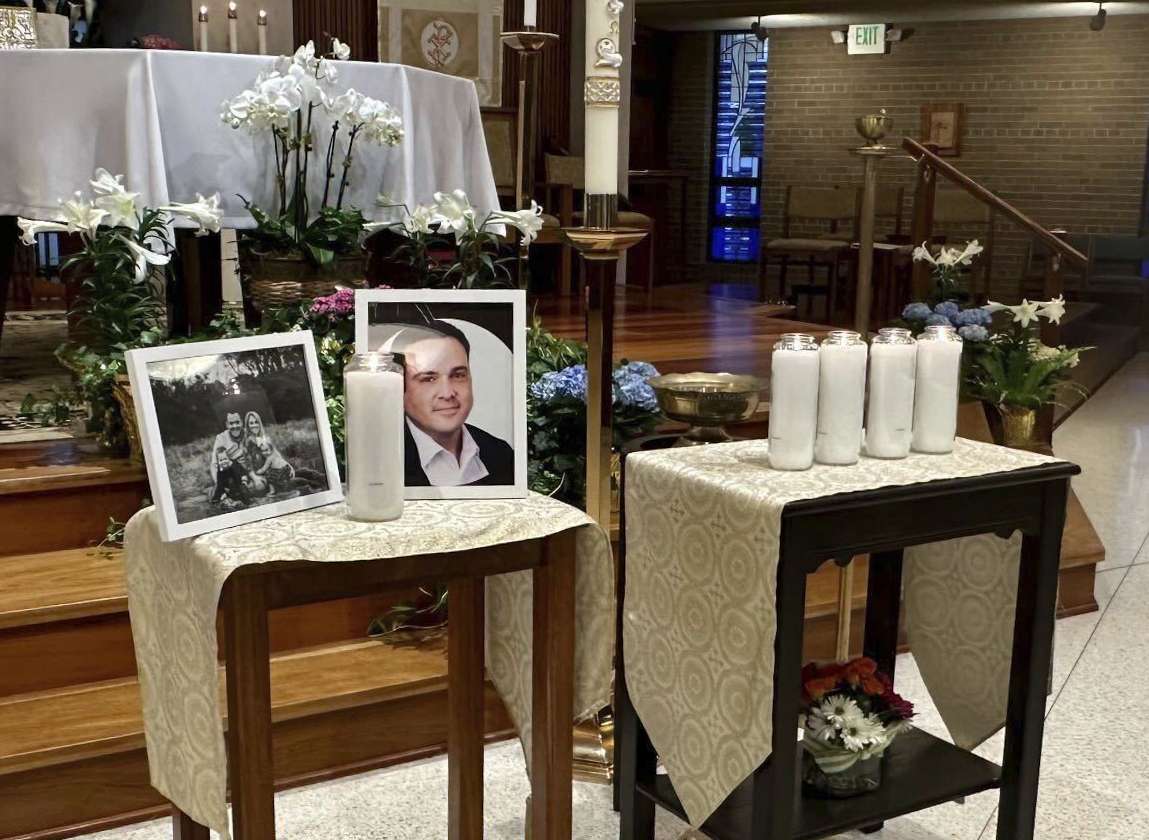 A memorial for Joshua Barrick is on display, late Monday at Holy Trinity Catholic Church in Louisville, Ky. A Louisville bank employee armed with a rifle opened fire at the bank Monday morning, killing Barrick and multiple others.