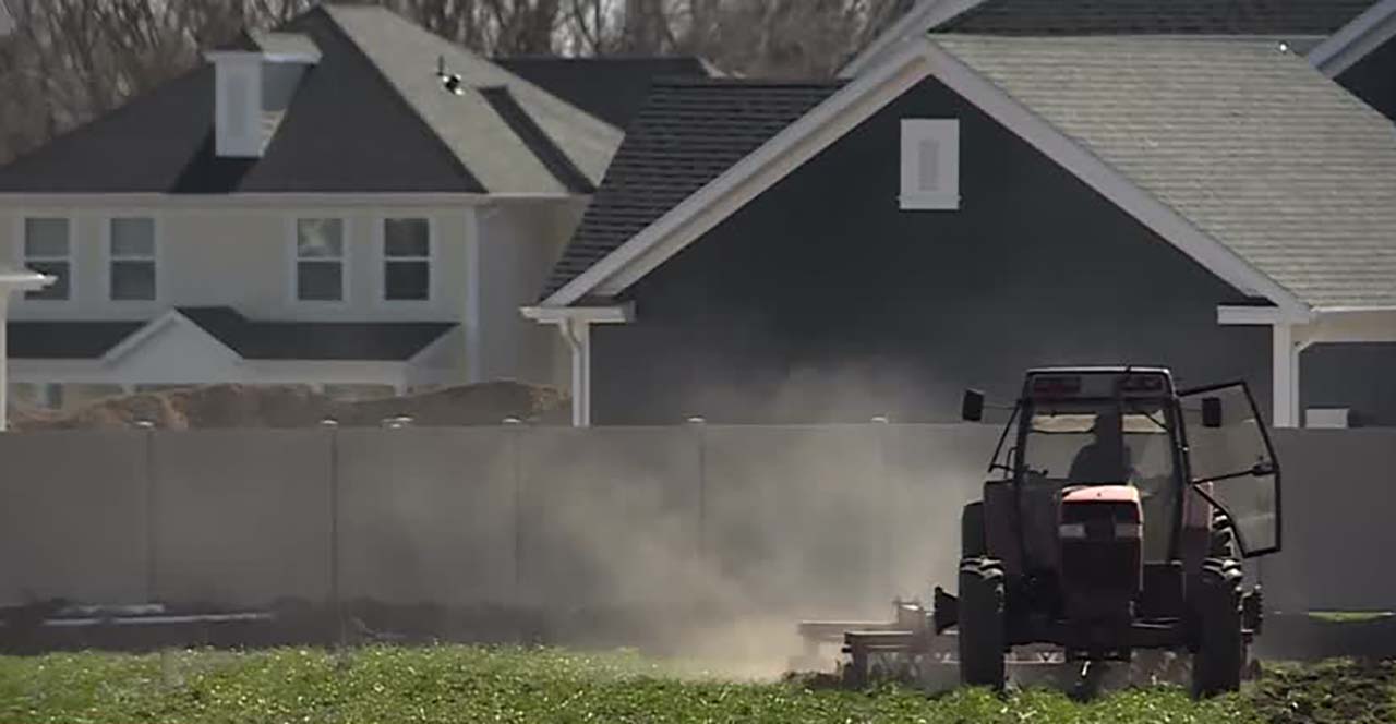 Tyson Roberts, who runs Roberts Family Farms, tills the ground for the first time this season on Monday in Layton. Crop planting is delayed because of wet weather.