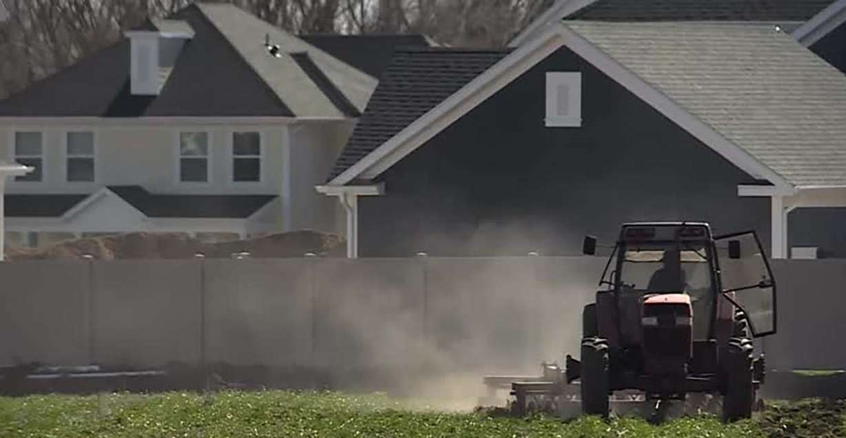 Tyson Roberts, who runs Roberts Family Farms, tills the ground for the first time this season on Monday in Layton. Crop planting is delayed because of wet weather.