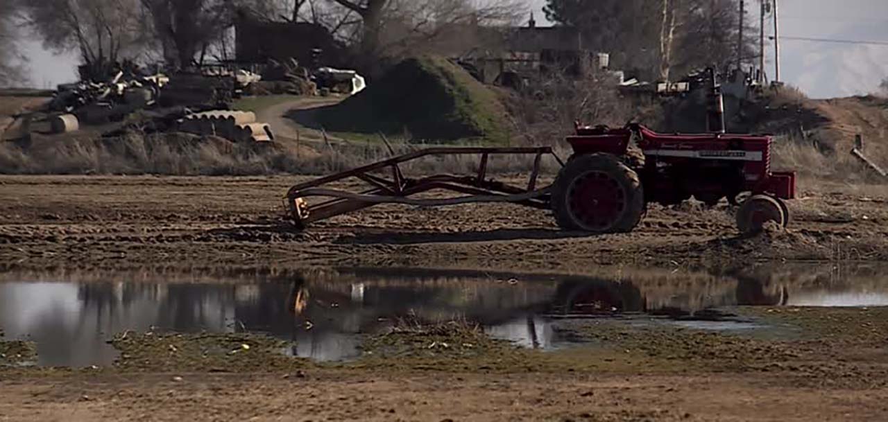 Equipment sits idle near Green Acres Dairy in Ogden Monday because the ground is too wet to plow. Ron Gibson runs the dairy and farms 2,000 acres of land.