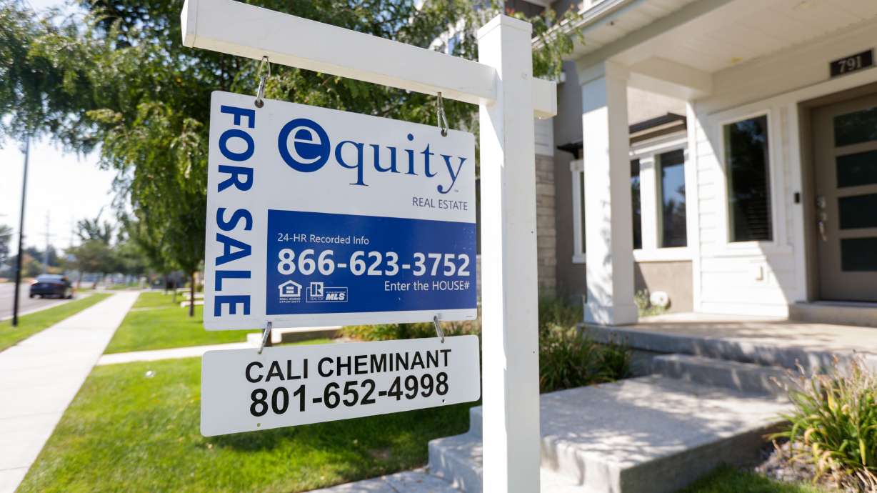 A “For sale” sign stands in front of town houses in Sandy on Sept. 9, 2022. As the U.S. housing market shows signs of stabilizing after over two years of upheaval amid the pandemic housing frenzy, the West continues to be the heart of home price correction.
