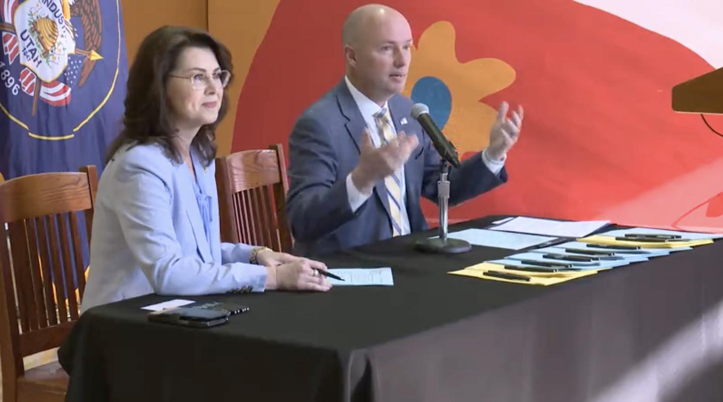 Utah Gov. Spencer Cox is joined by Lt. Gov. Deidre Henderson at a ceremonial signing of domestic violence bills at YWCA Utah in Salt Lake City on Tuesday.