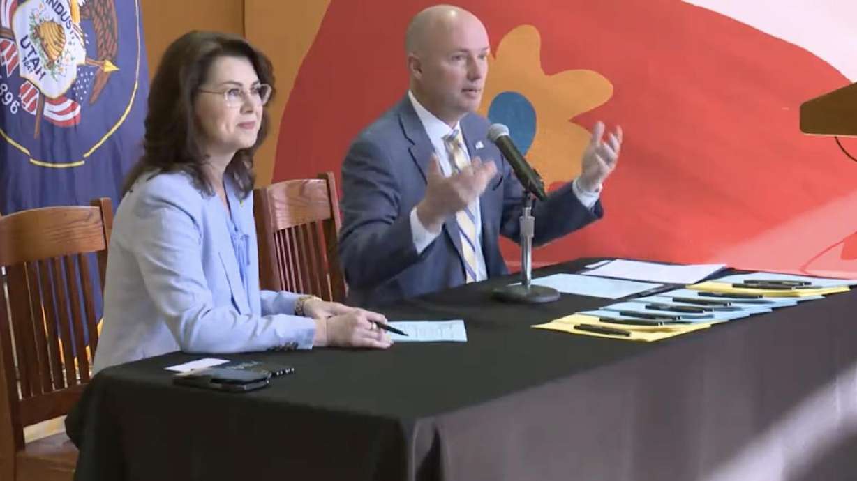 Utah Gov. Spencer Cox is joined by Lt. Gov. Deidre Henderson at a ceremonial signing of domestic violence bills at YWCA Utah in Salt Lake City on Tuesday.