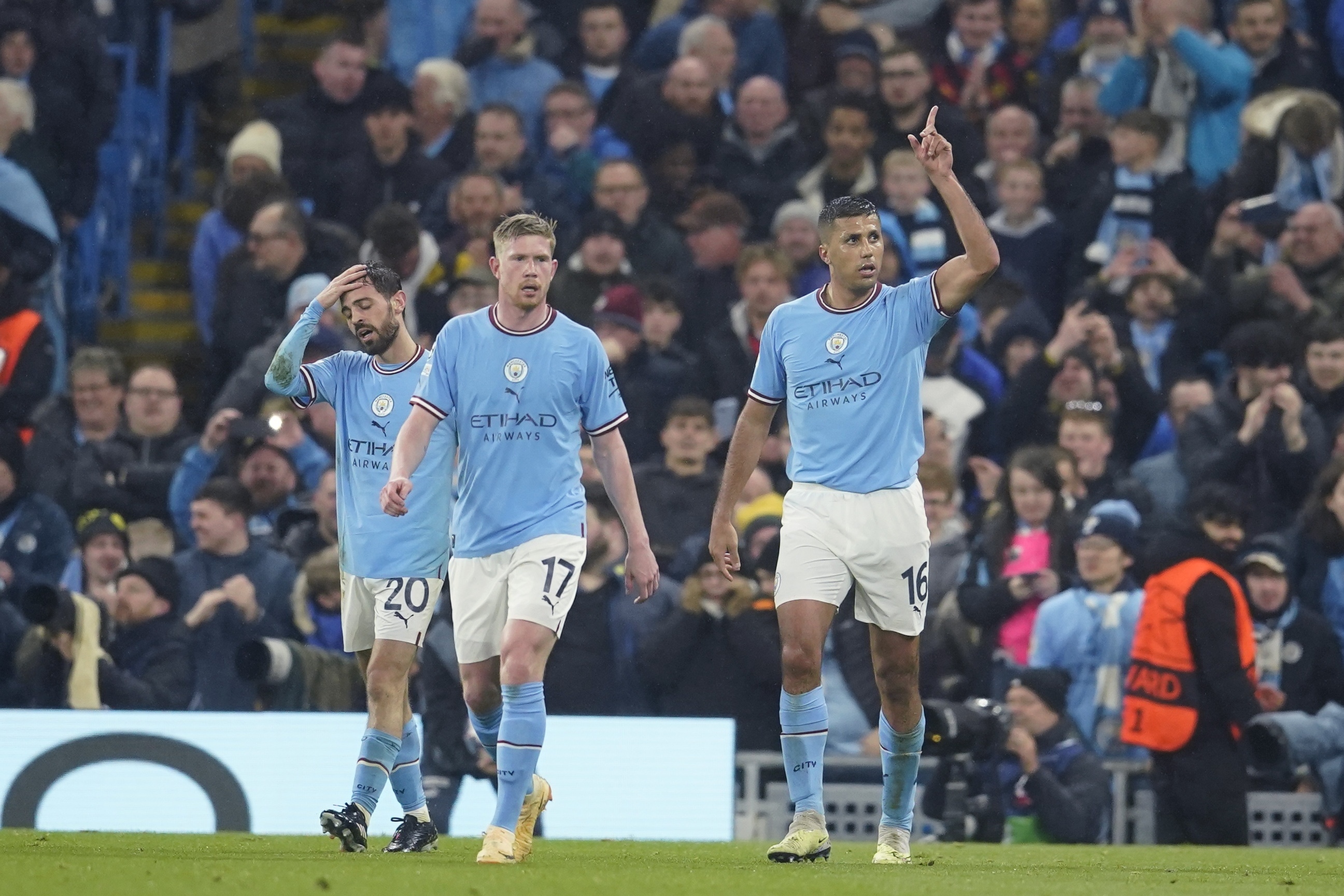 Manchester City's Rodrigo, right, celebrates after scoring the opening goal of his team during the Champions League quarterfinal, first leg, soccer match between Manchester City and Bayern Munich at the Etihad stadium in Manchester, England, Tuesday, April 11, 2023. 