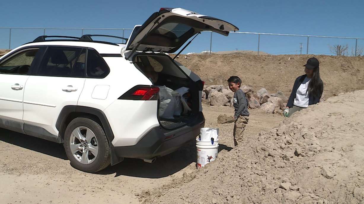 Joanne Wong fills up sandbags in Lehi. From Lehi to St. George, water officials and residents are watching how the warmer temperatures are impacting spring runoff and the risk of flooding.