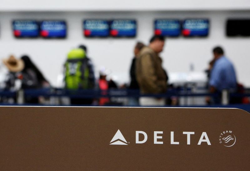 Passengers check in at a counter of Delta Air Lines in Mexico City, Mexico, August 8, 2016.
