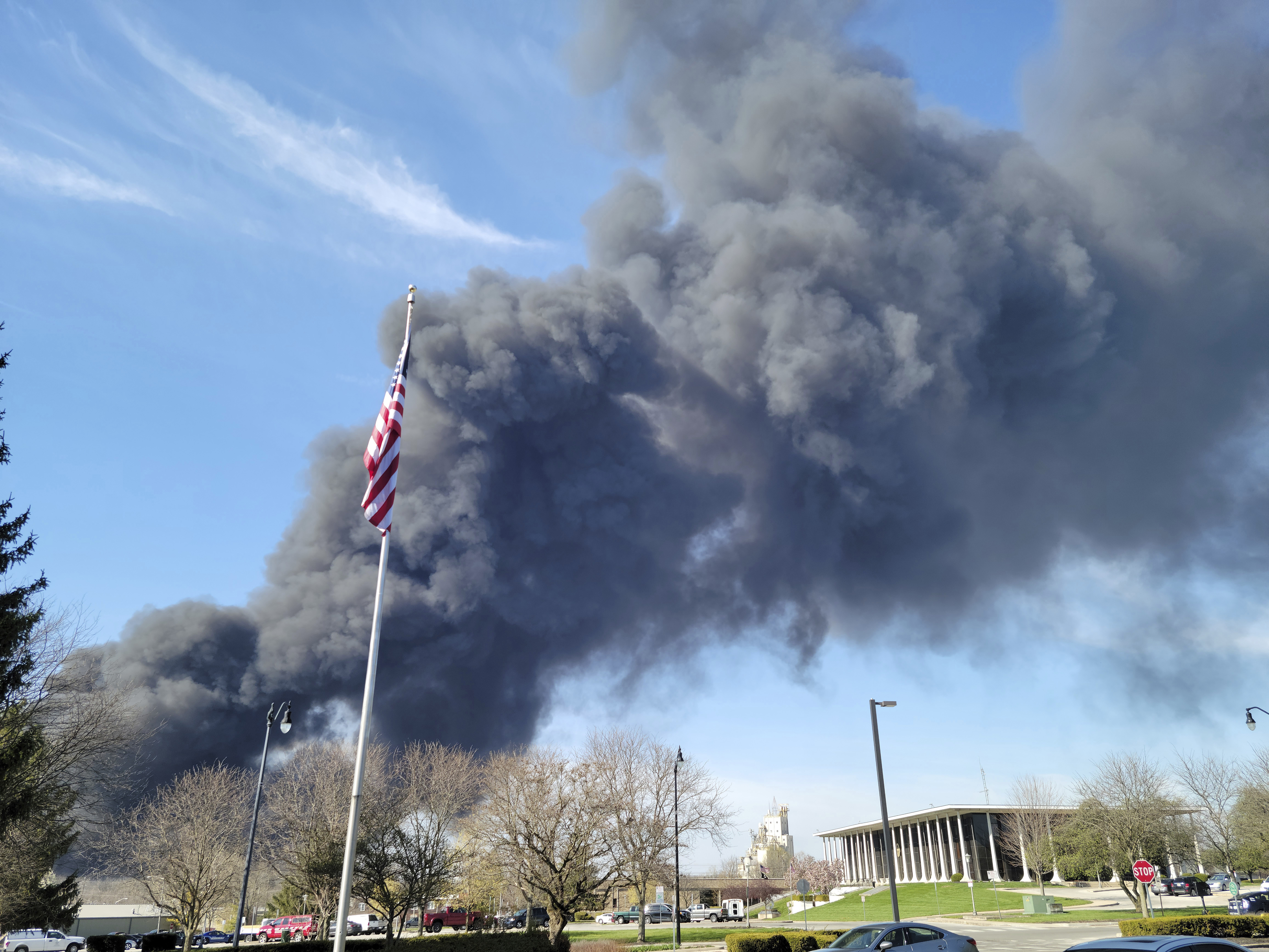 Smoke rises from an industrial fire, Tuesday at 358 NW F Street, in Richmond, Ind. Richmond fire chief Tim Brown says multiple fires continued burning Wednesday morning within about 14 acres of various types of plastics stored both inside and outside buildings at the former factory site in Richmond, 70 miles east of Indianapolis.