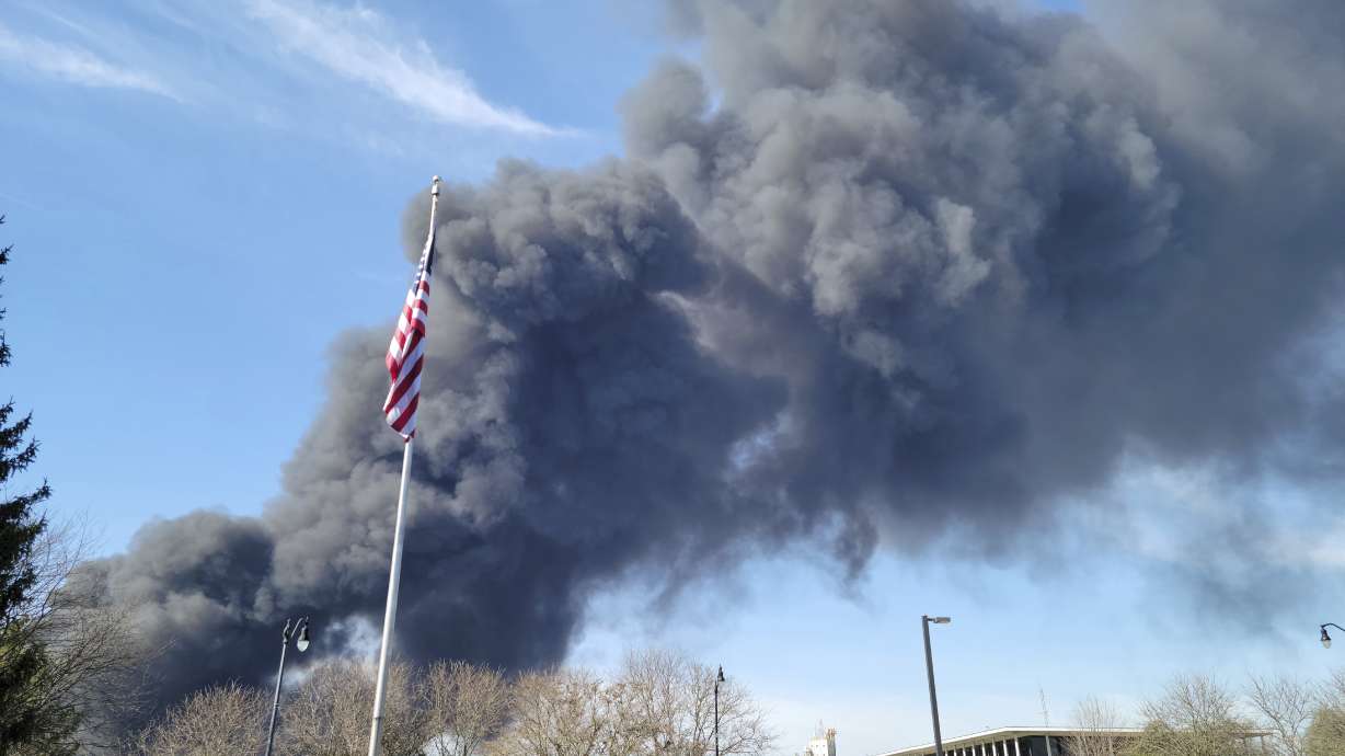 Smoke rises from an industrial fire, Tuesday at 358 NW F Street, in Richmond, Ind. Richmond fire chief Tim Brown says multiple fires continued burning Wednesday morning within about 14 acres of various types of plastics stored both inside and outside buildings at the former factory site in Richmond, 70 miles east of Indianapolis.
