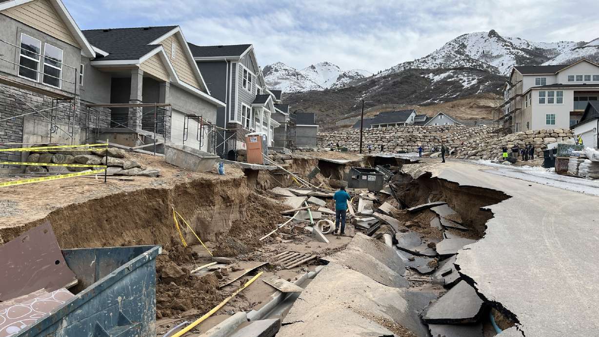 A street is damaged by flooding in Kaysville on April 12. Gov. Spencer Cox issued a state of emergency over flooding in Utah on Tuesday.