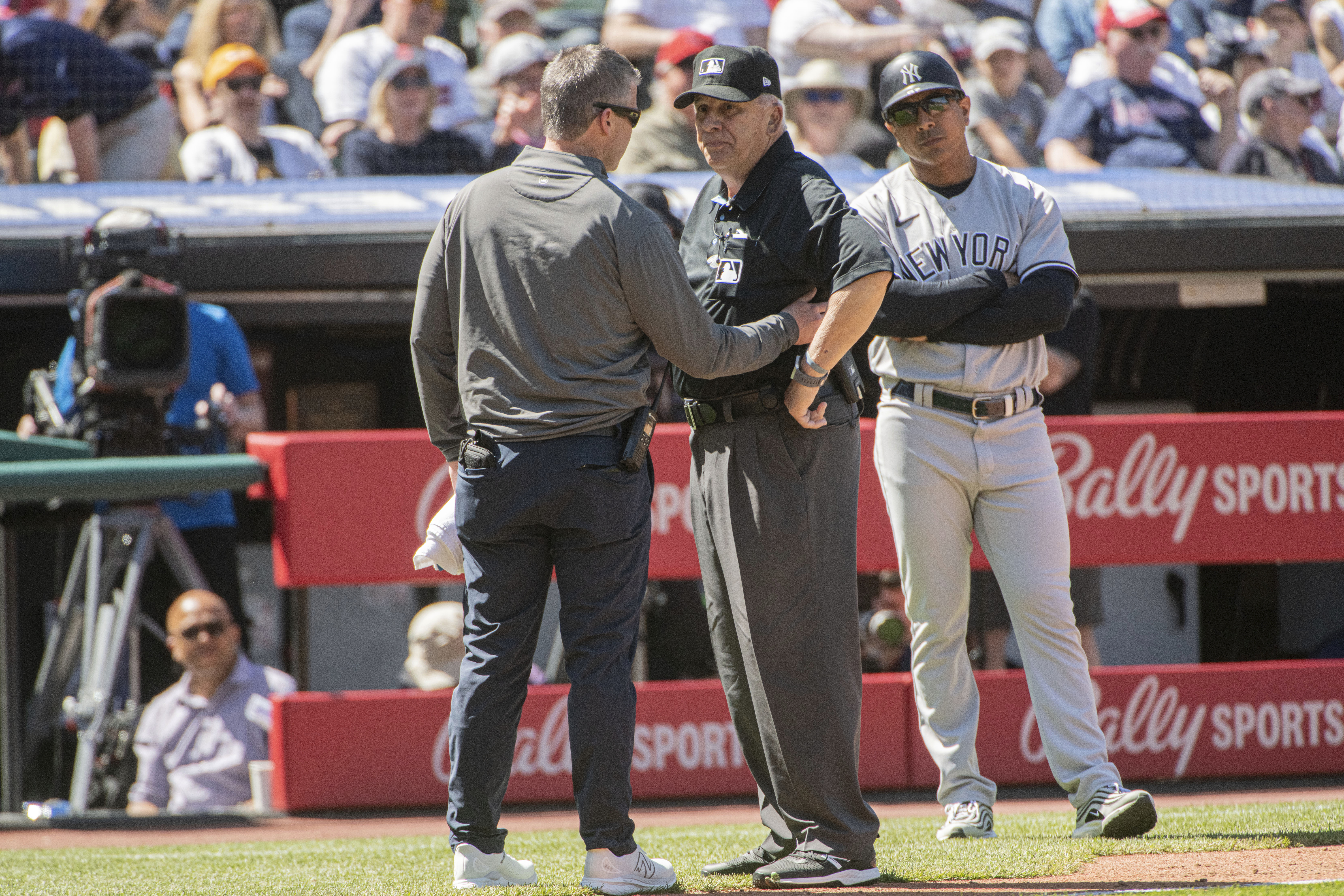 Umpire Larry Vanover is attended to by a Cleveland Guardians trainer after being hit by a throw from the outfield during the fifth inning of a baseball game in Cleveland, Wednesday April 12, 2023. Vanover left the game because of the injury. 