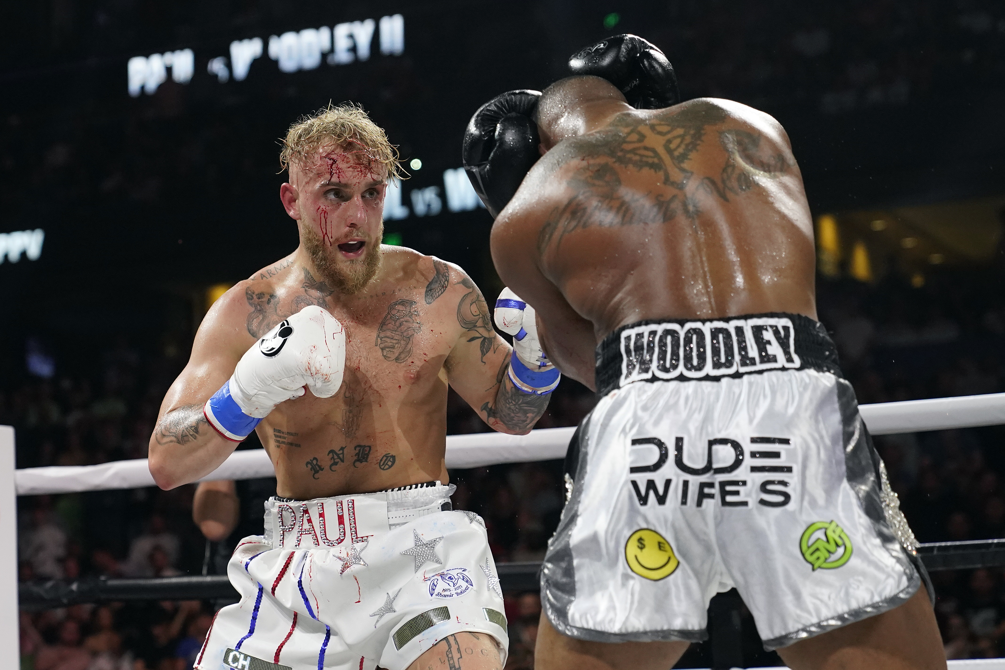 FILE - Jake Paul, left, punches Tyron Woodley during the second round of a Cruiserweight fight on Dec. 19, 2021, in Tampa, Fla. YouTube sensation Paul will take on former UFC veteran Nick Diaz in a boxing match on Aug. 5, 2023, in Dallas. 
