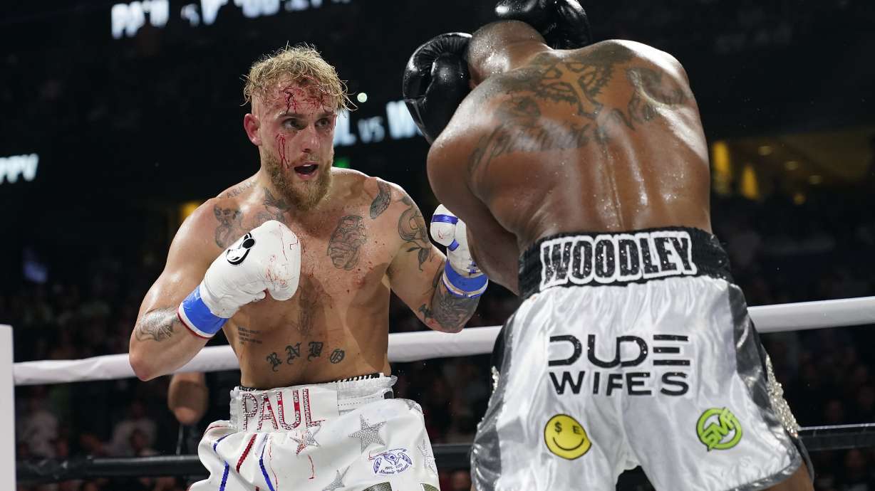 FILE - Jake Paul, left, punches Tyron Woodley during the second round of a Cruiserweight fight on Dec. 19, 2021, in Tampa, Fla. YouTube sensation Paul will take on former UFC veteran Nick Diaz in a boxing match on Aug. 5, 2023, in Dallas.