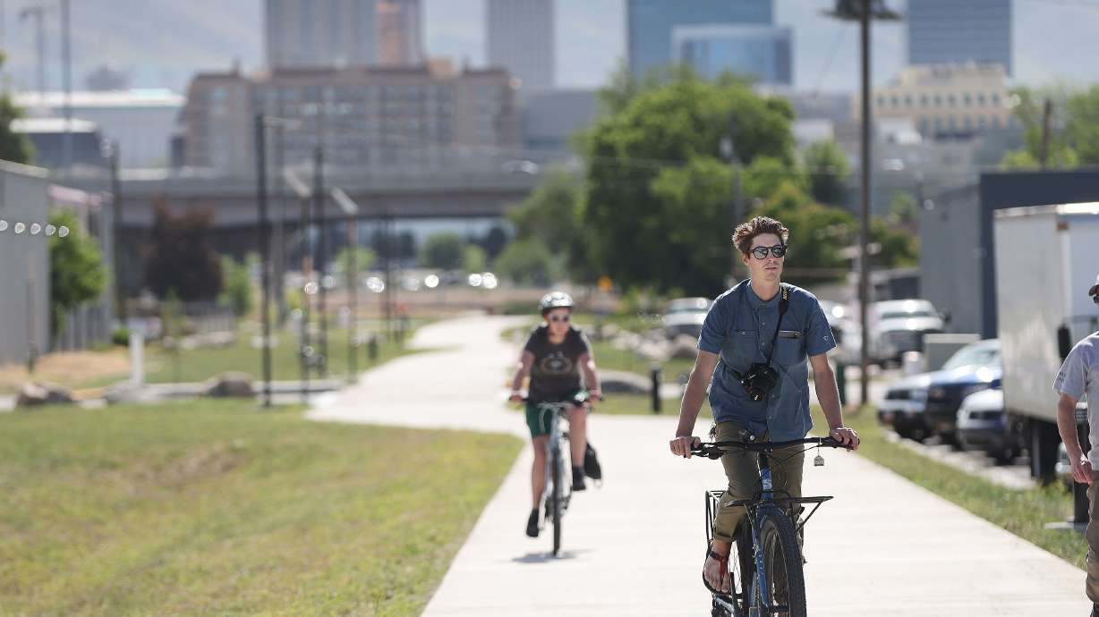 Brian Tonetti and Evelyn Lamb ride on the Folsom Trail in Salt Lake City after it opened for the first time on June 7, 2022. Funding to complete the trail is set to be raised with the first tranche of a voter-approved parks bond.
