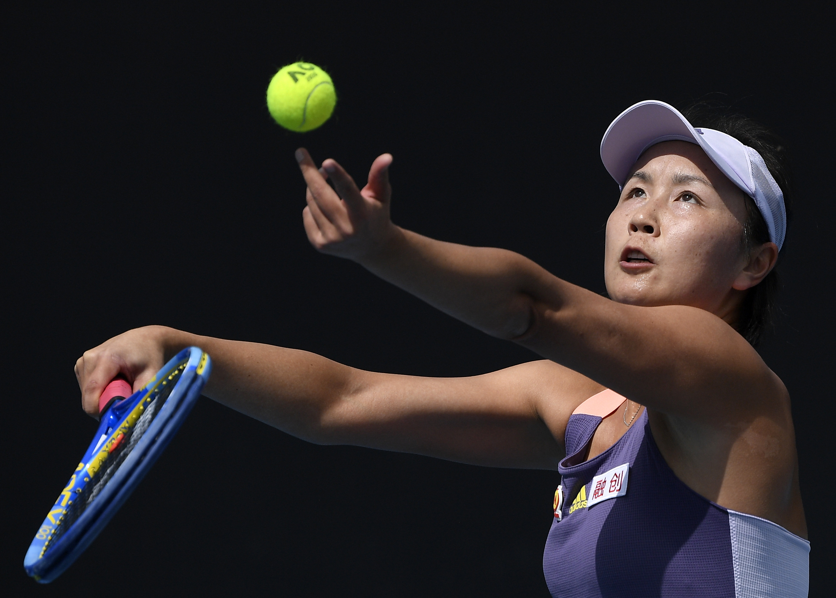 FILE - China's Peng Shuai serves to Japan's Nao Hibino during their first round singles match at the Australian Open tennis championship in Melbourne, Australia, Jan. 21, 2020. The women’s professional tennis tour is ending its suspension of tournaments in China that was initiated in late 2021 over concerns about Grand Slam doubles champion Peng Shuai’s well-being. The WTA announced Thursday, April 13, 2023, that it will return to competition in China this season, even though two of its key requests were never met: a chance to meet with Peng, and a thorough, transparent investigation of her sexual assault accusations against a high-ranking Chinese government official. 