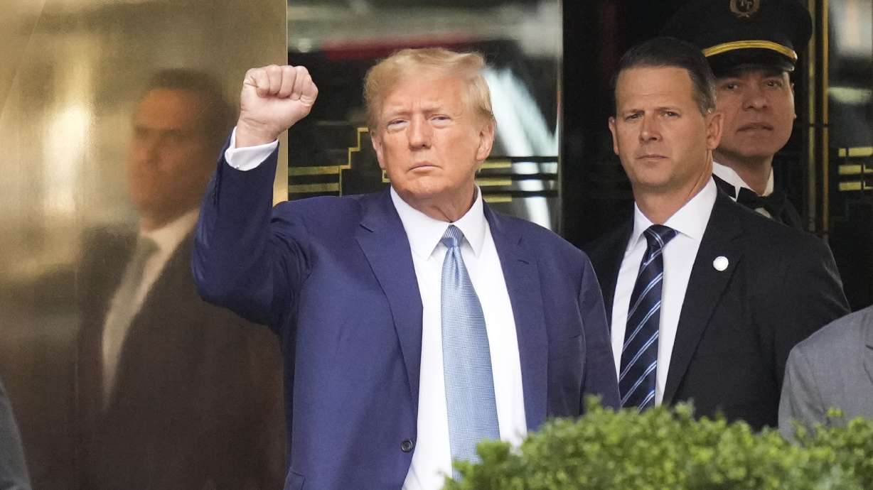 Former President Donald Trump, left, gestures as he leaves Trump Tower in New York City on Thursday. Trump answered questions for hours during his second deposition in a legal battle with New York's attorney general over business practices.