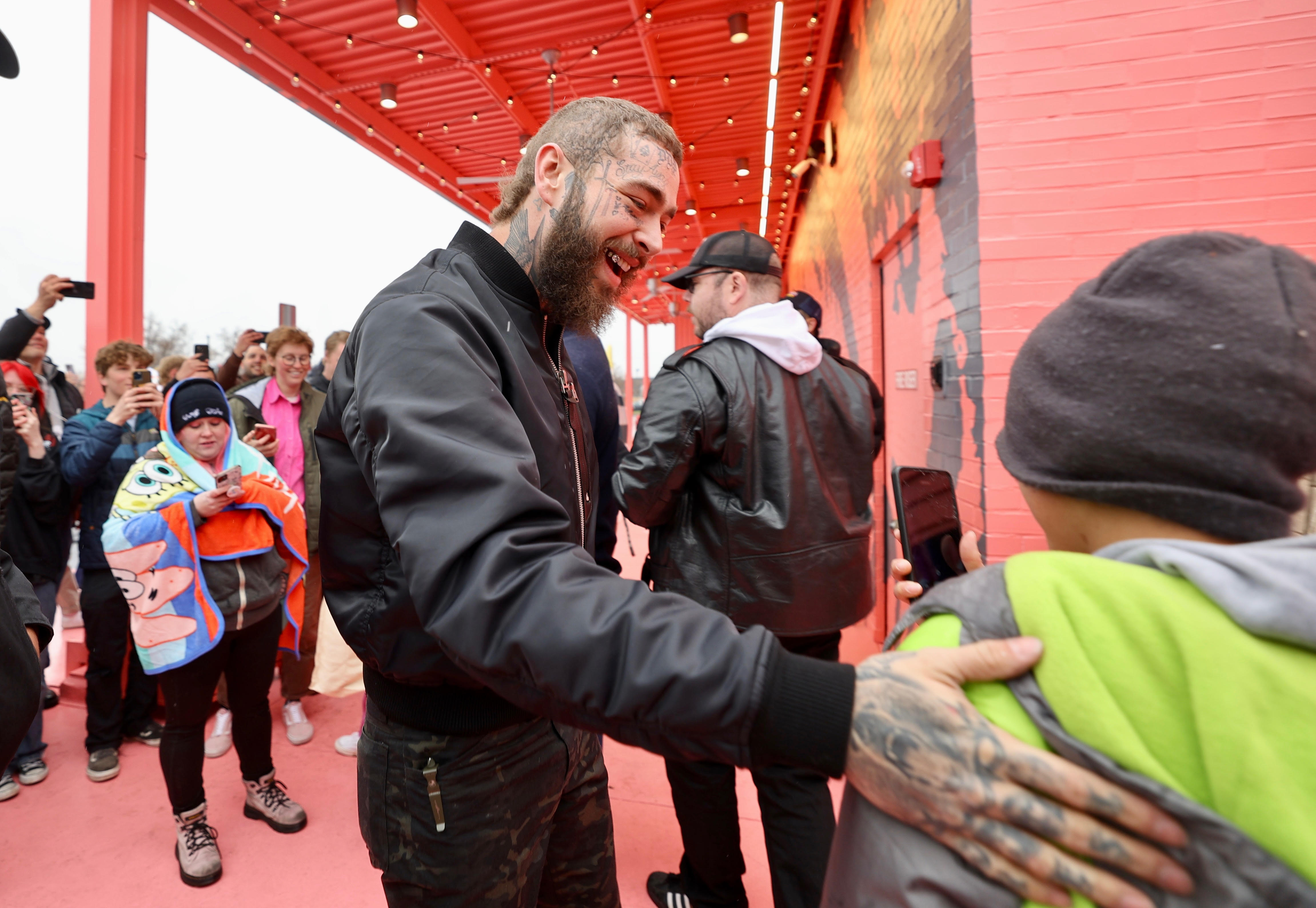 Post Malone cuts ribbon on custom-designed Raising Cane's restaurant